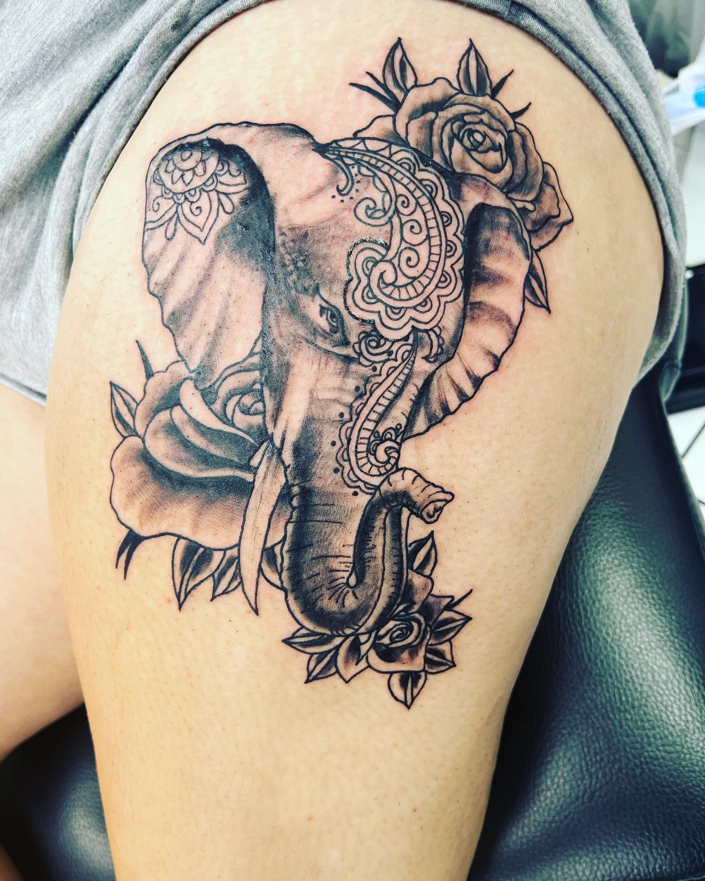 Elephant and roses ornamental tattoo on the thigh by Frankie Sodapop Plumley