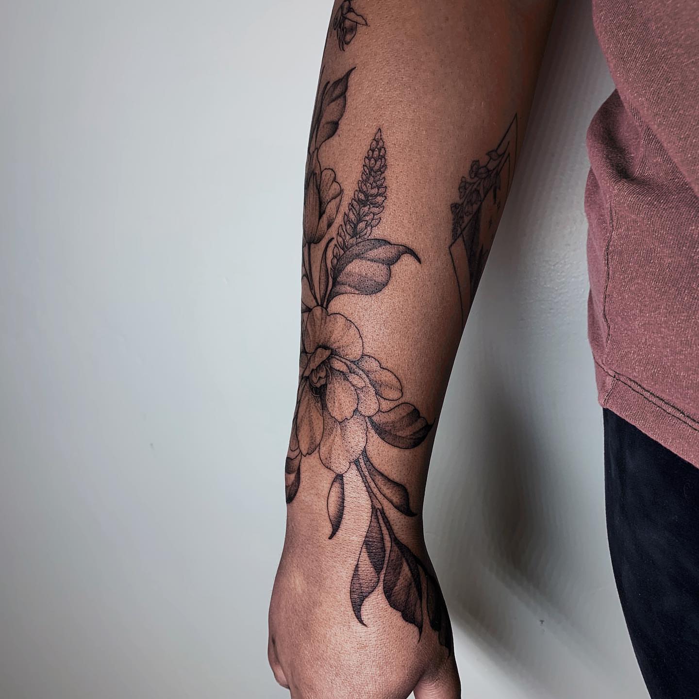 Floral arrangement black and grey tattoo on the forearm by Kolby