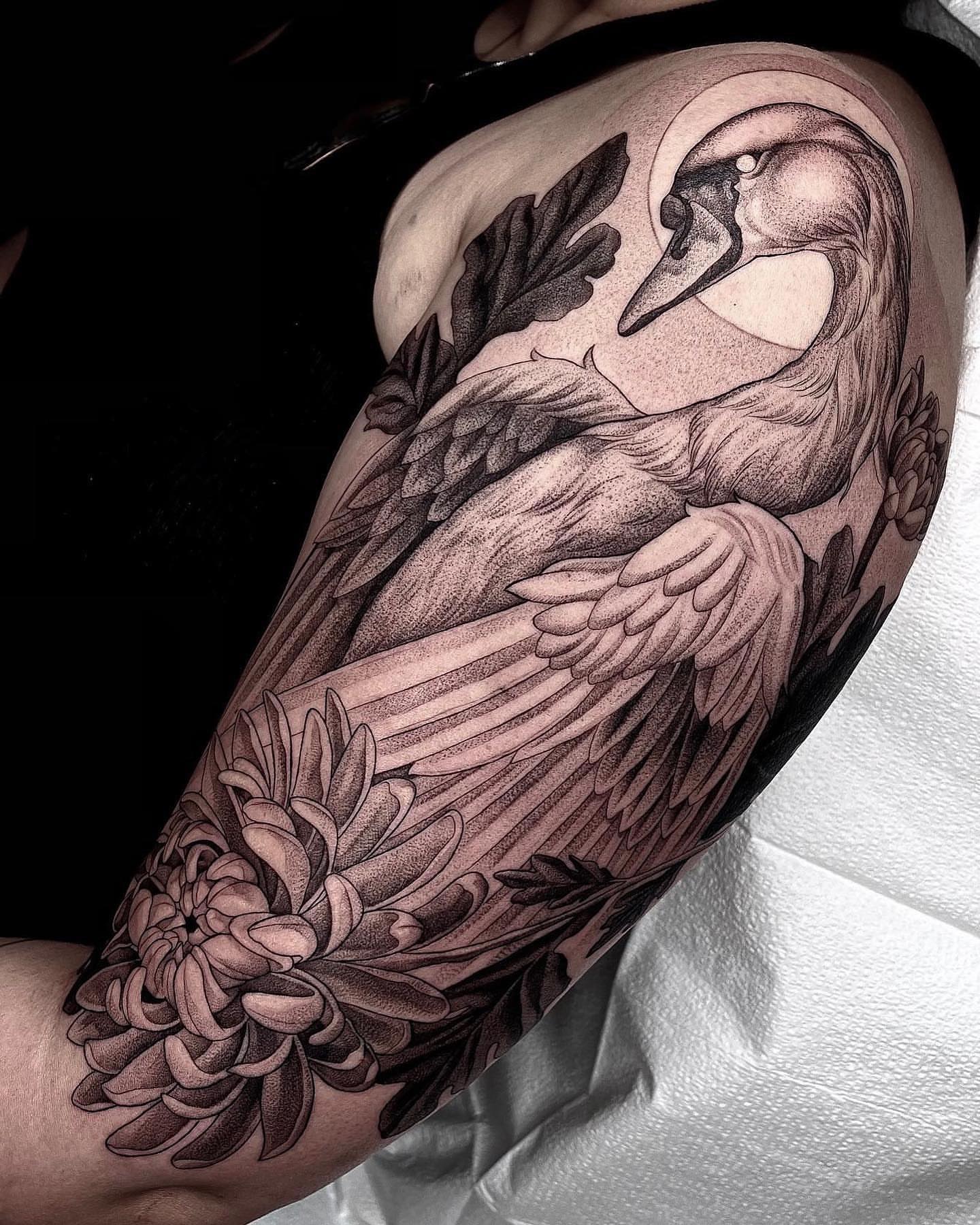 Swan and chrysanthemum realism tattoo on the forearm by Enrique Martinez