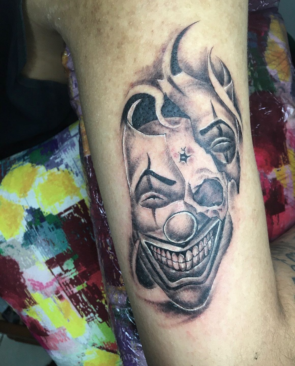 Clown face realism tattoo on the forearm by la flamme