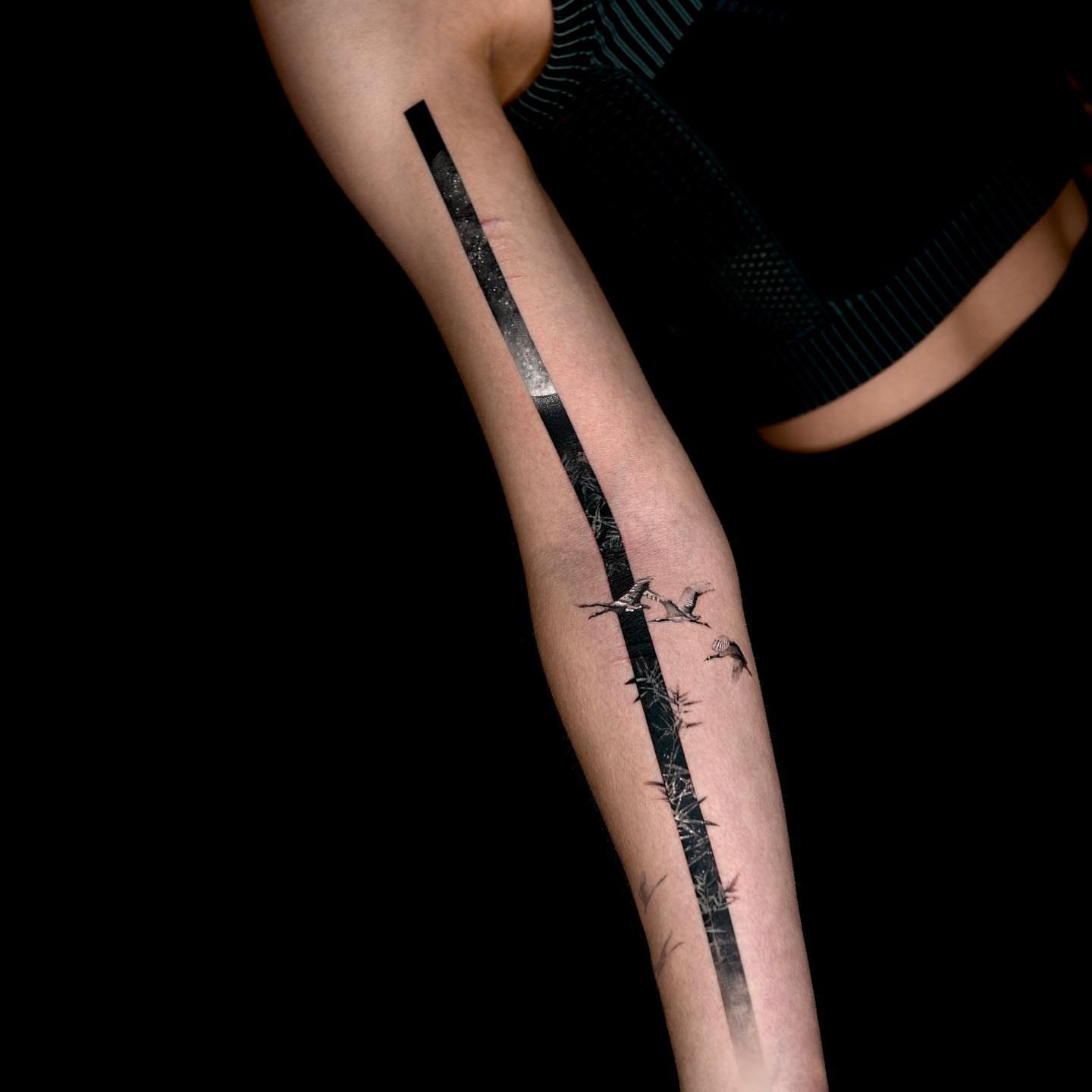 Bamboo and birds minimalist tattoo on the forearm by Rizn