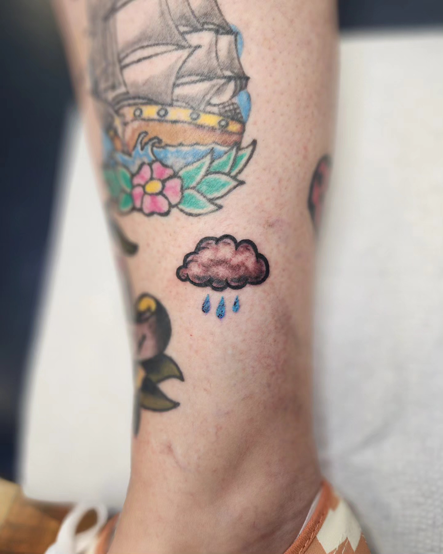 Ship and flowers American traditional tattoo on the forearm by Bry True