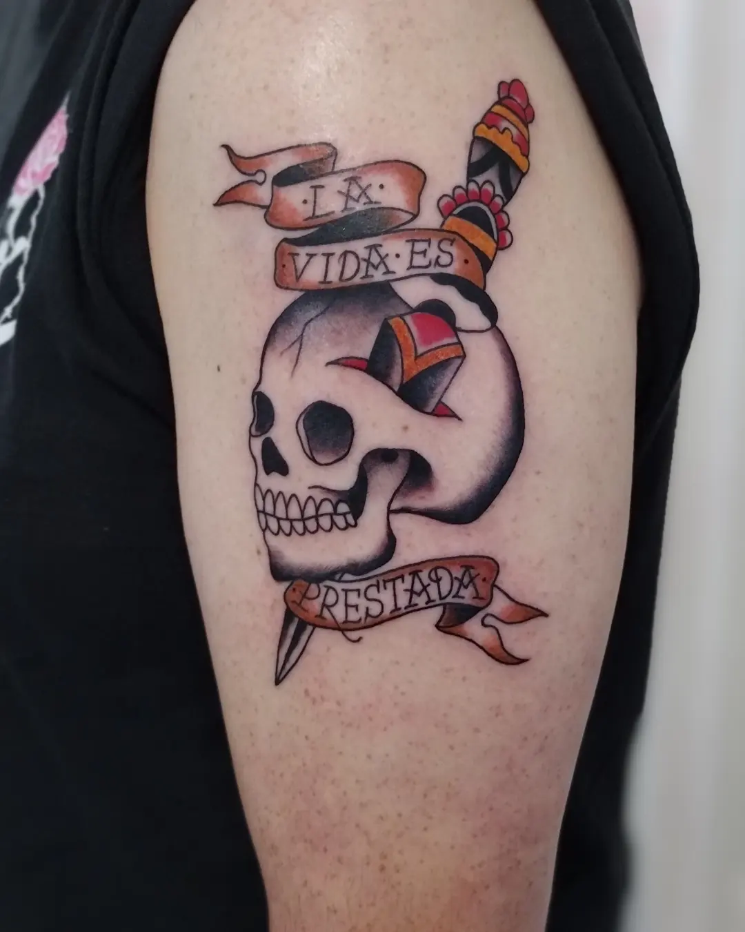 Skull with banner American traditional tattoo on the shoulder by Herc