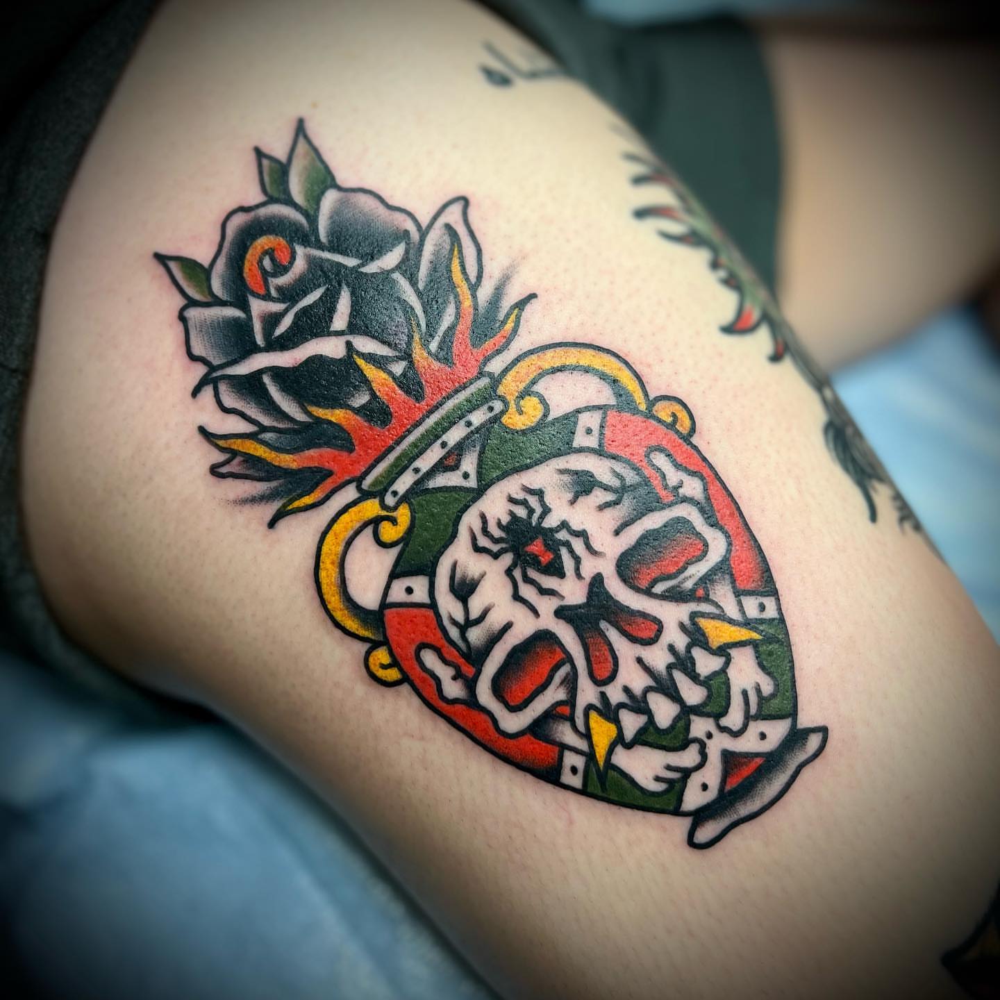 Skull and rose American traditional tattoo on the thigh by Troy Mort, Altoona, Pennsylvania