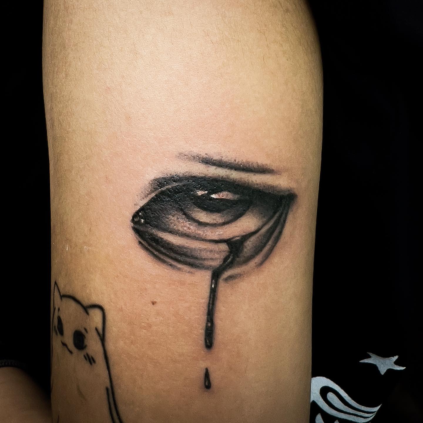 Tearful eye realism tattoo on the forearm by Neeko