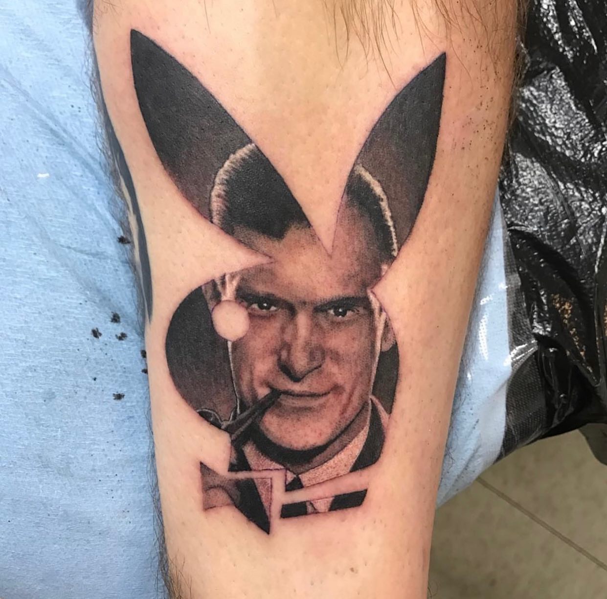 Playboy bunny logo realism tattoo on the forearm by Justin Hendrick