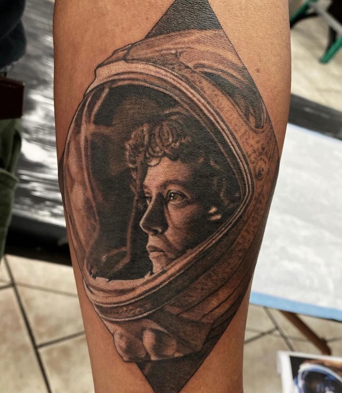 Astronaut helmet realism tattoo on the forearm by Justin Hendrick
