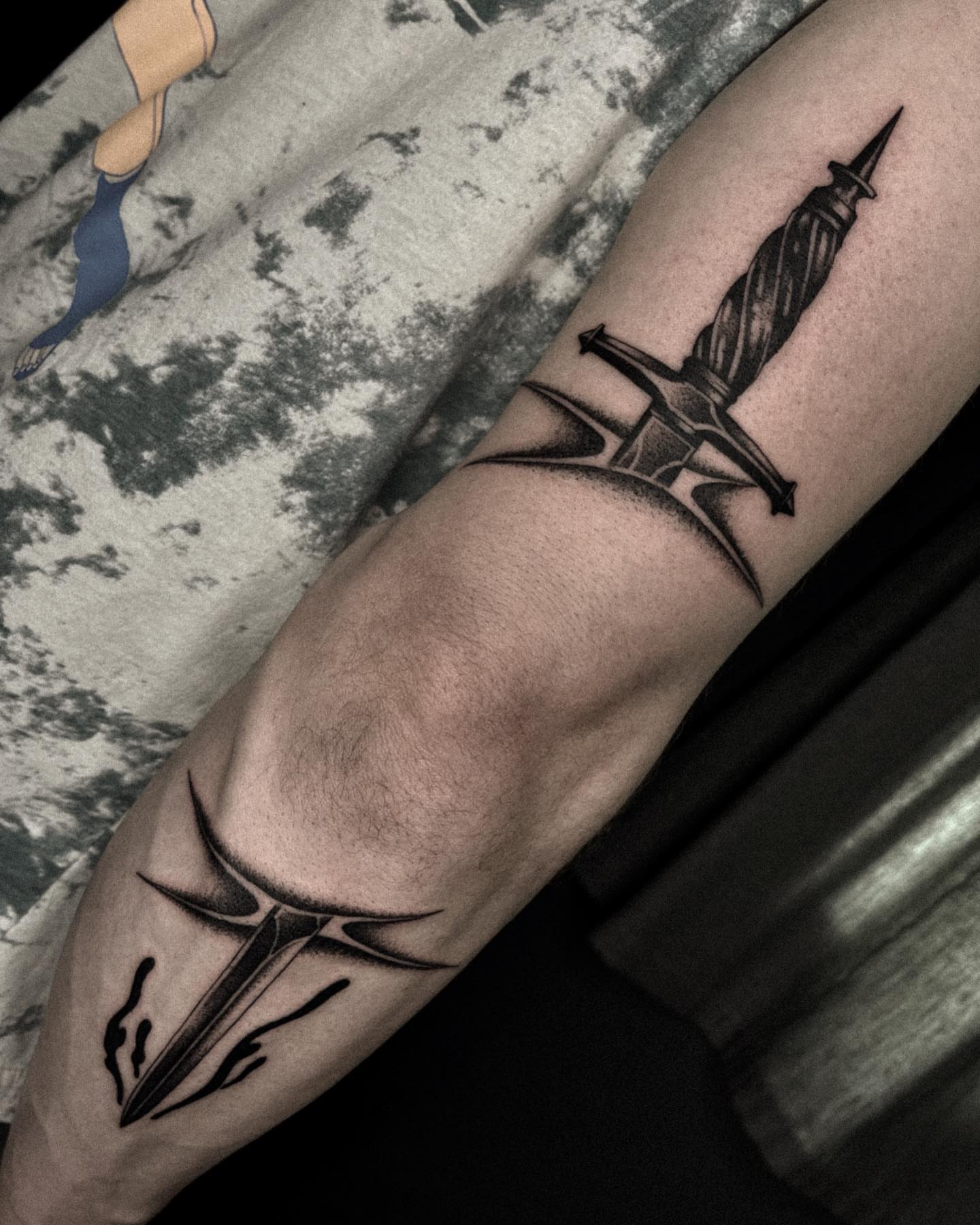 Sword and cross black and grey tattoo on the forearm by David Ha