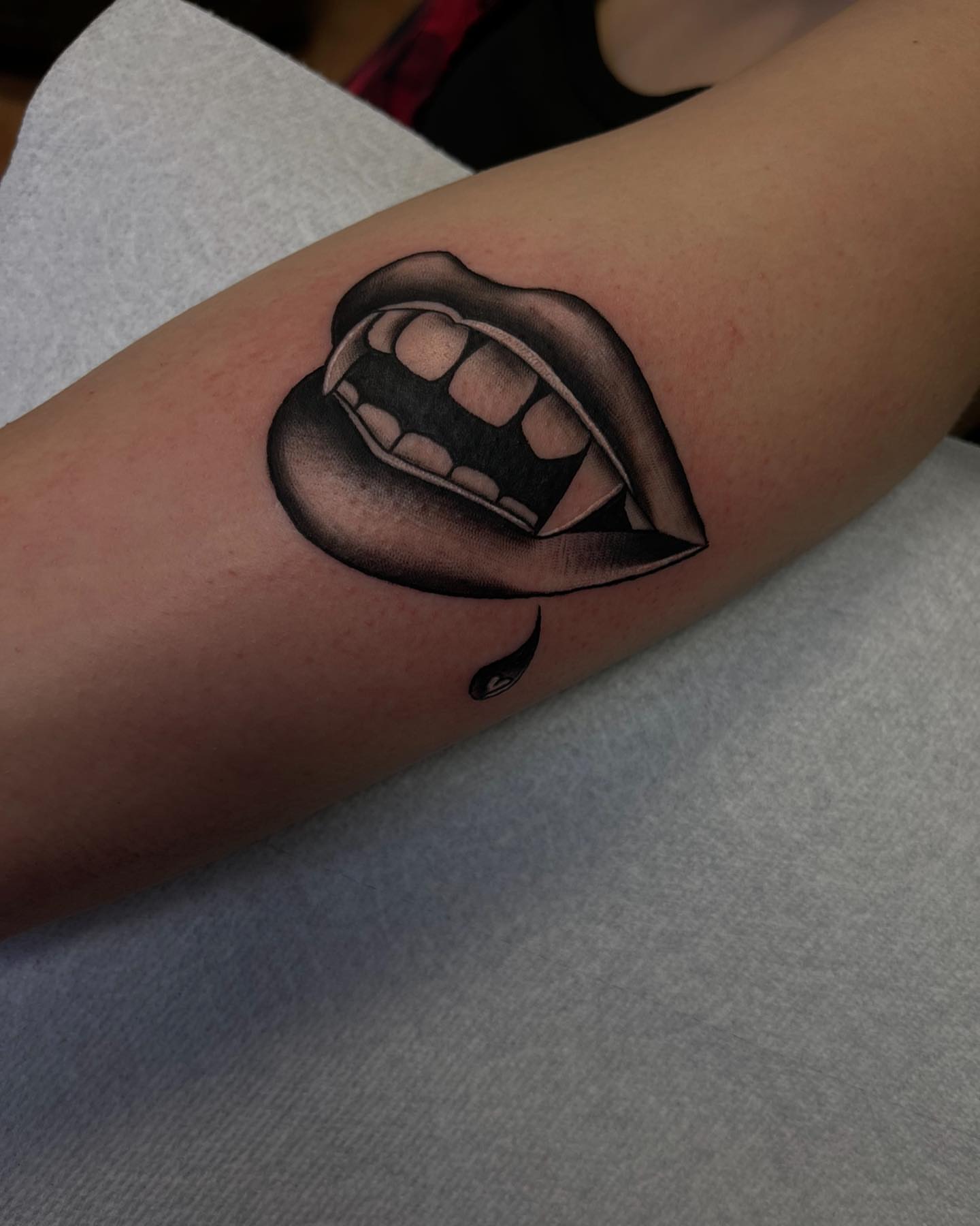Fangs and drool black and grey tattoo on the forearm by Las Vegas Tattoo Artist