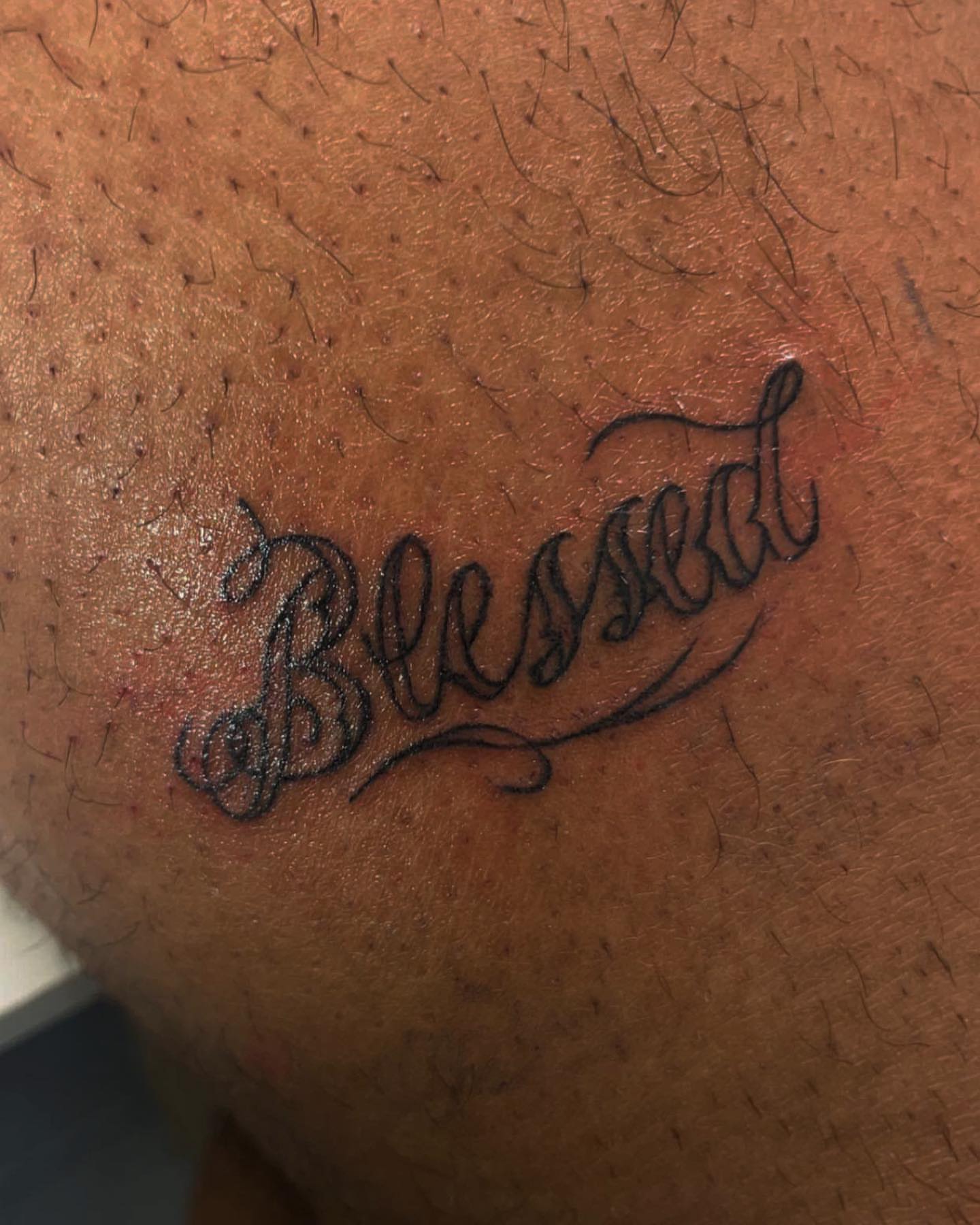 Blessed lettering script tattoo on the thigh by Bear