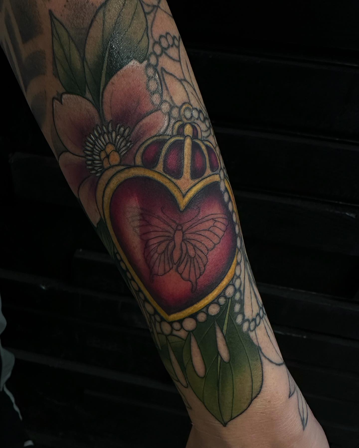 Heart with crown and butterfly American traditional tattoo on the forearm by audi