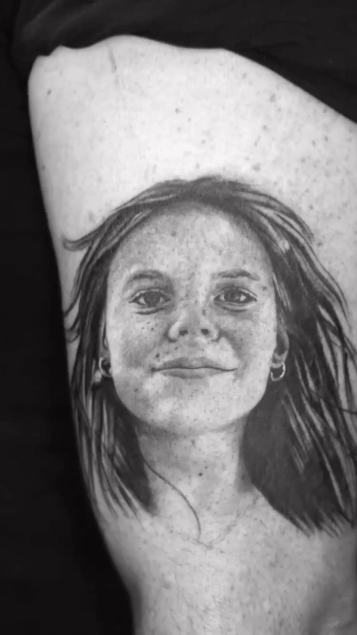 Portrait of a young woman realism tattoo by Remko
