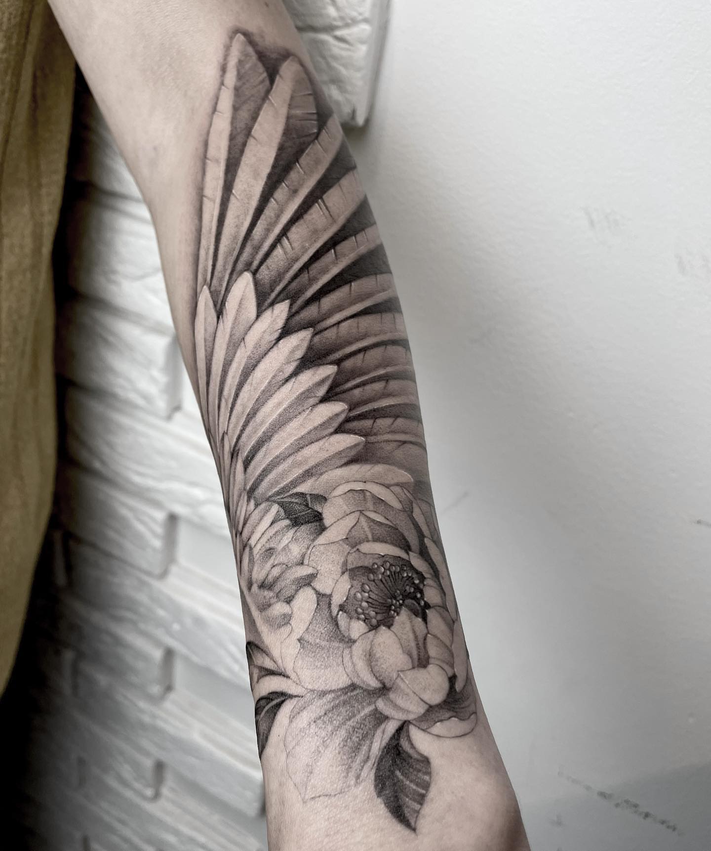 Peony and leaves realism tattoo on the forearm by Annie Overchuk