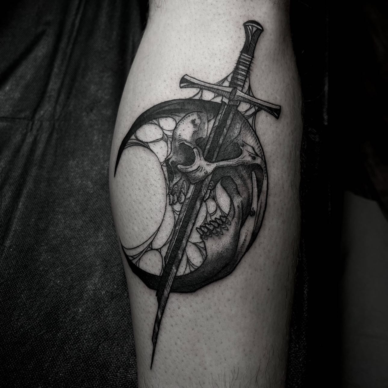 Skull and sword geometric tattoo on the forearm by t a y l o r