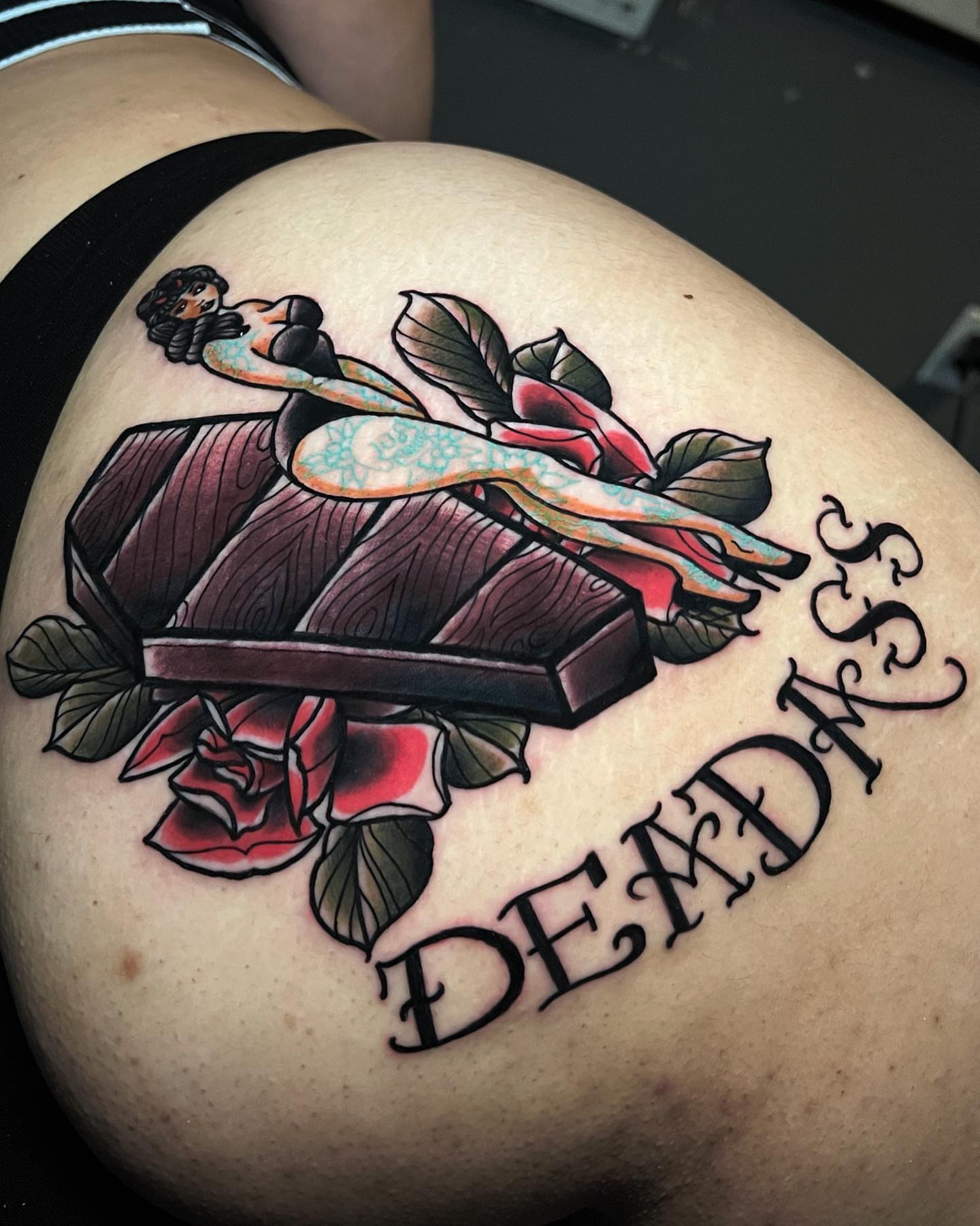 Woman lying on book American traditional tattoo on the thigh by Raul Ortiz