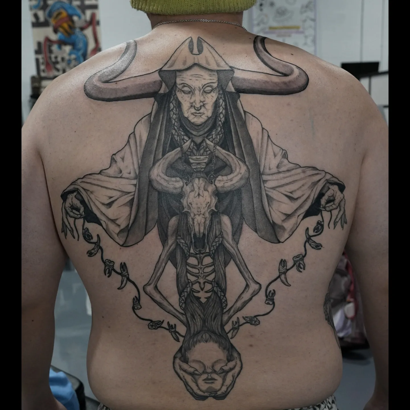 Bull skull and hooded figure realism tattoo on the back by EyeSee Tattoos