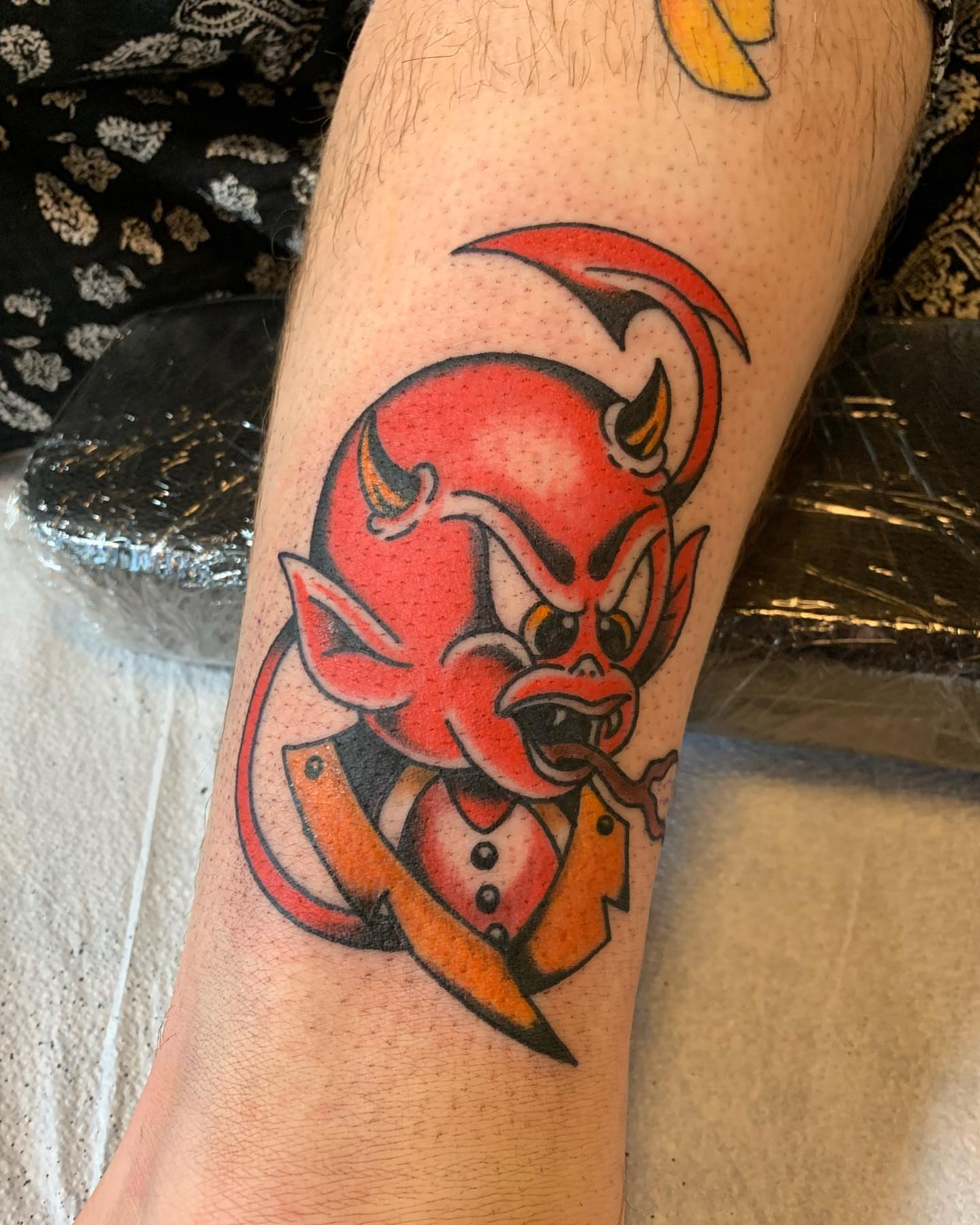Red devil American traditional tattoo on the forearm by Ethan Bennett
