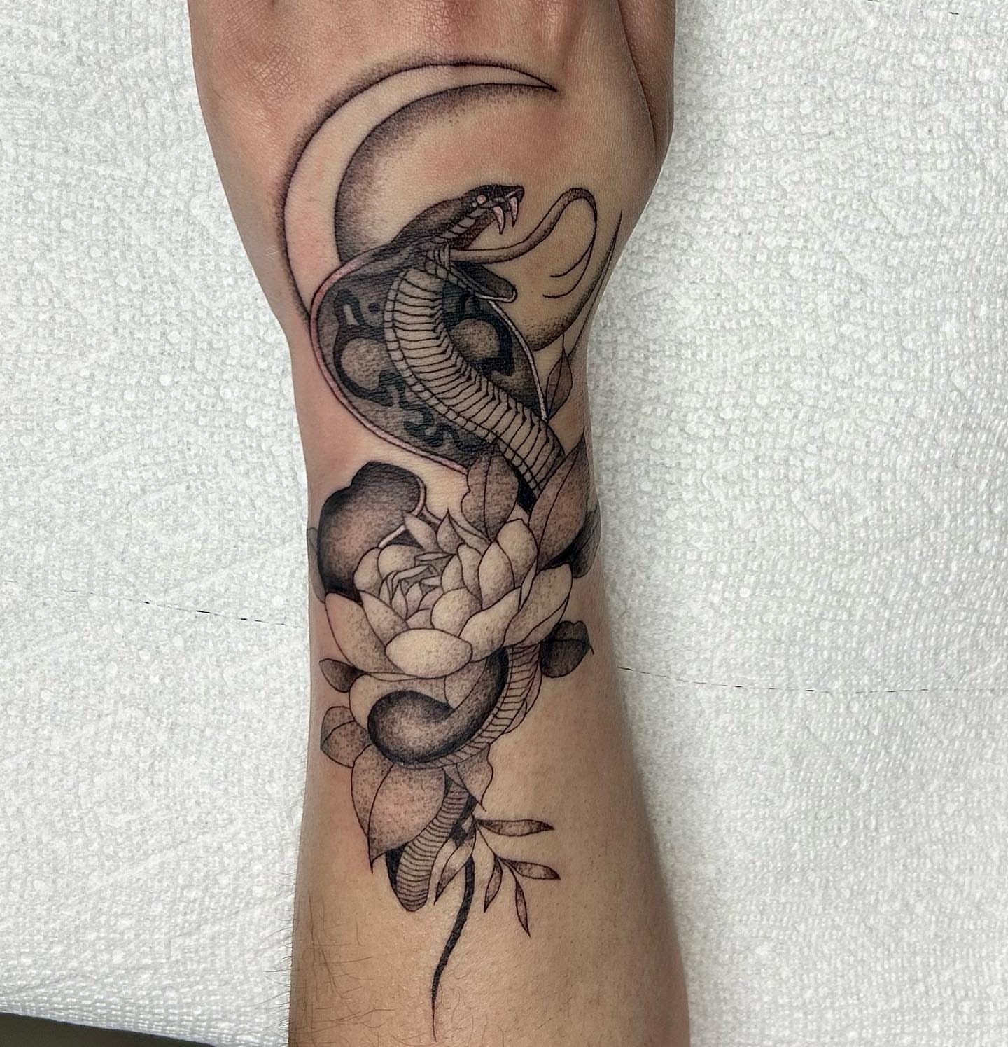 Snake and peony black and grey tattoo on the forearm by LilDebbie Tatts