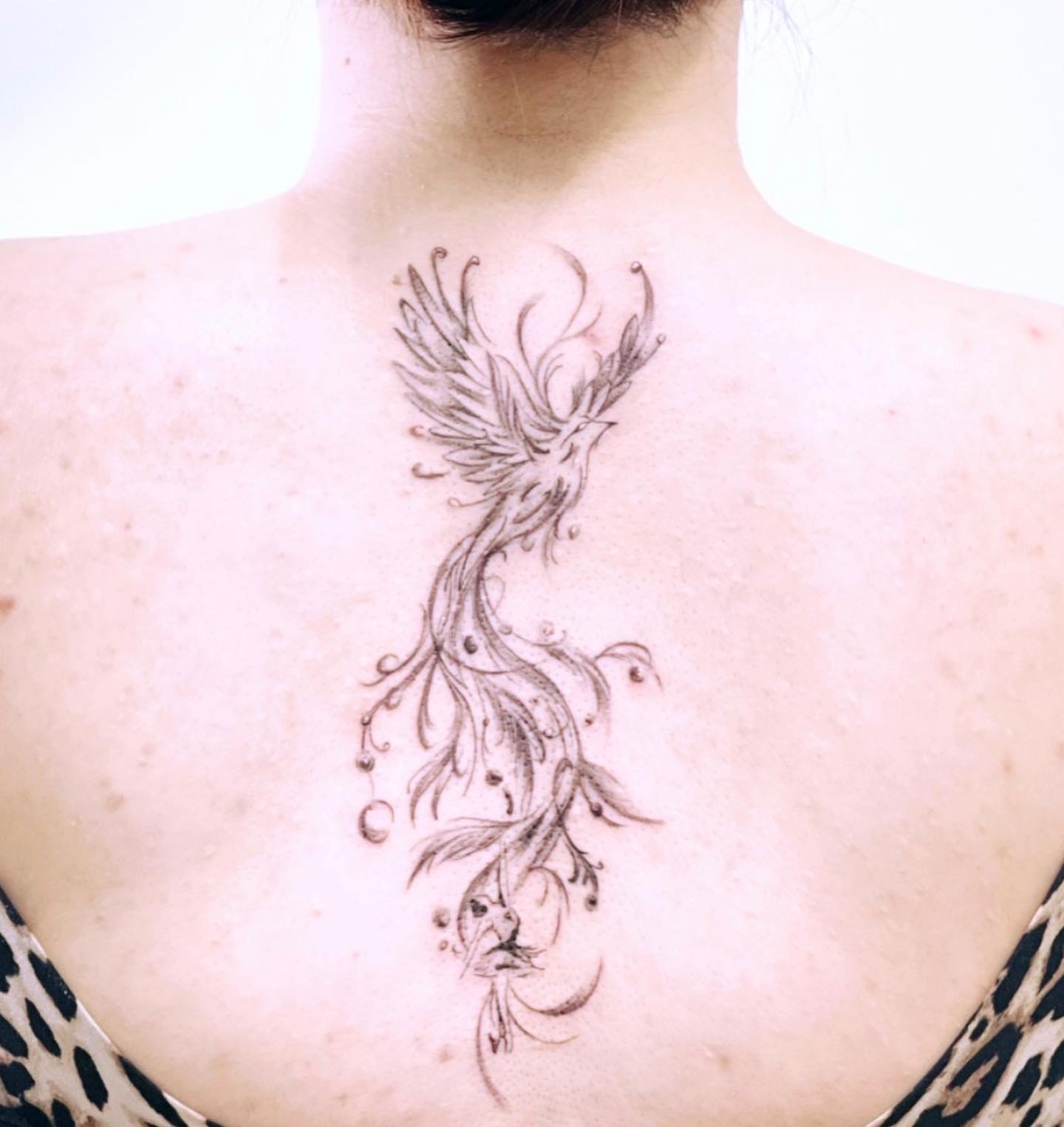 Phoenix black and grey tattoo on the chest by Banky