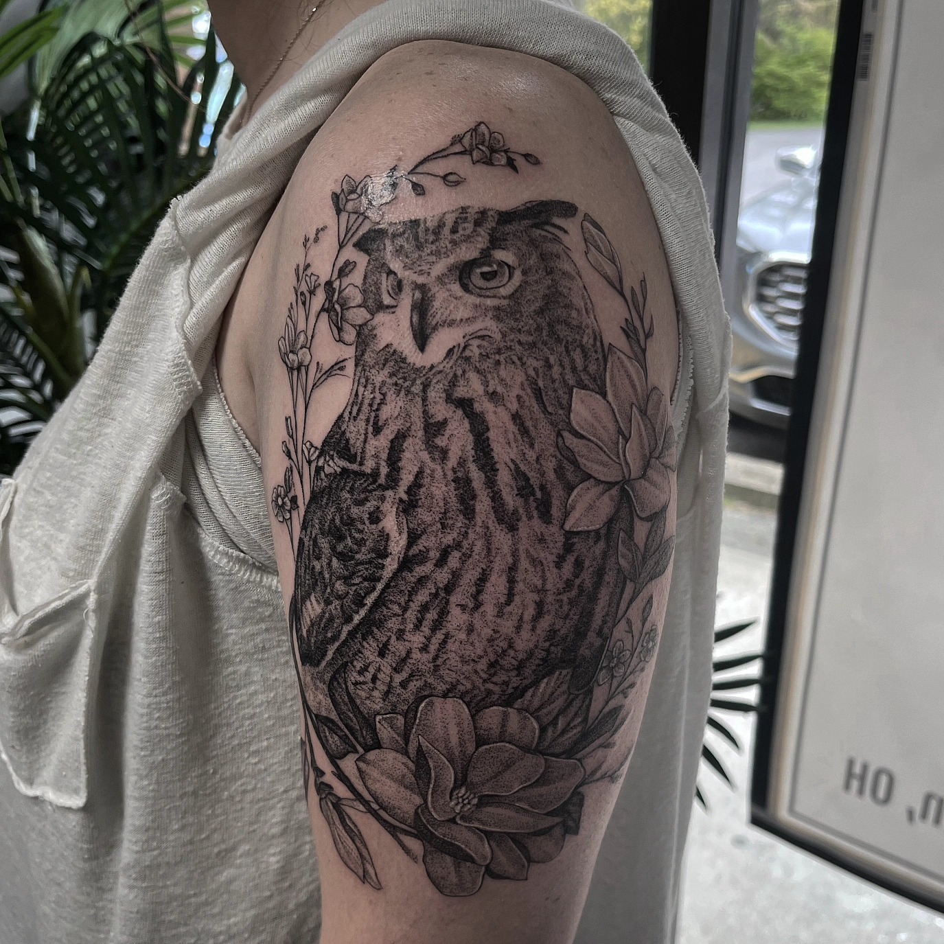 Owl black and grey tattoo on the upper arm by Kyle Joseph [tattoo artist]
