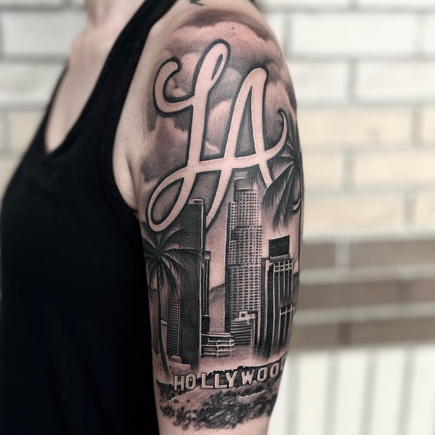 LA skyline realism tattoo on the forearm by Jake Fujimura