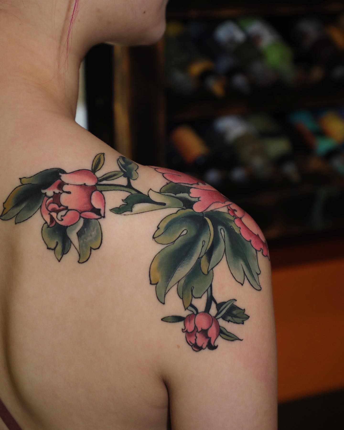 Peony flowers American traditional tattoo on the shoulder by Diego Romay