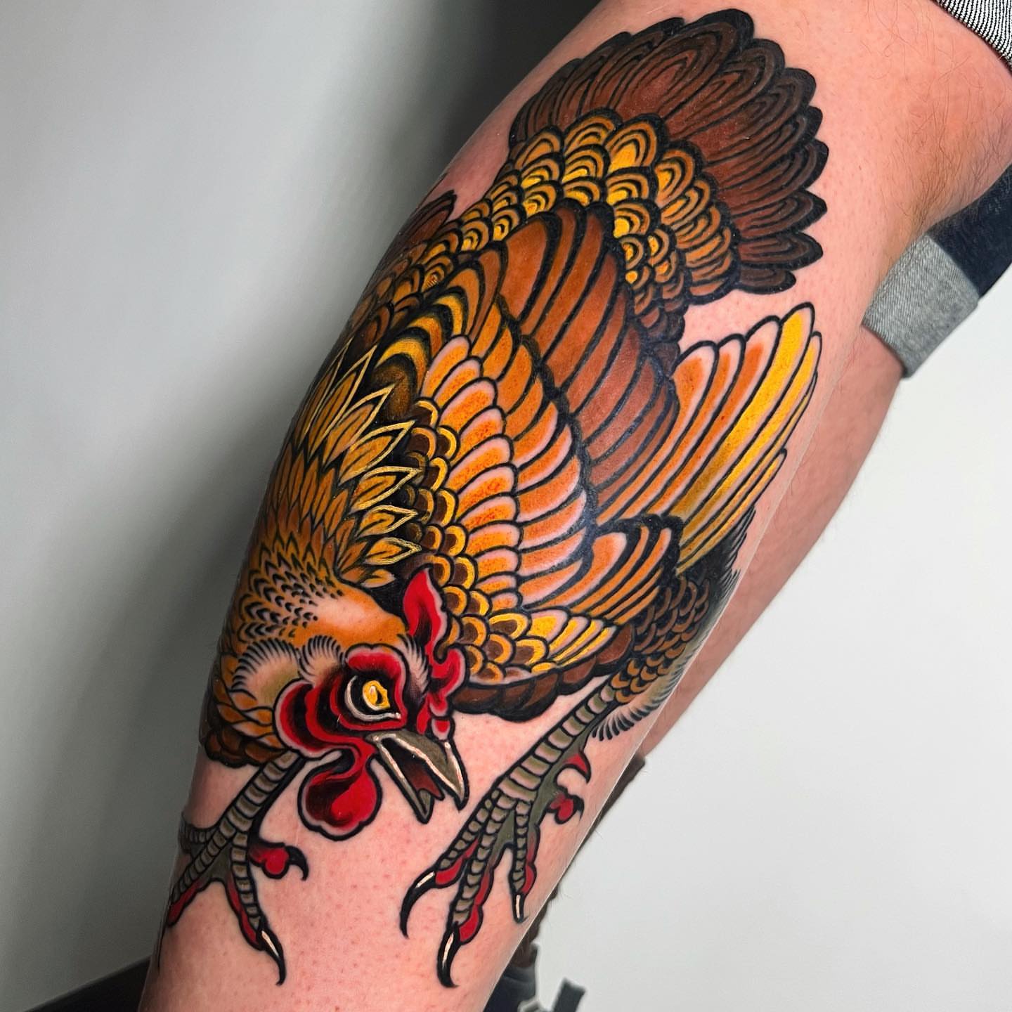 Rooster American traditional tattoo on the forearm by Sara Lewis