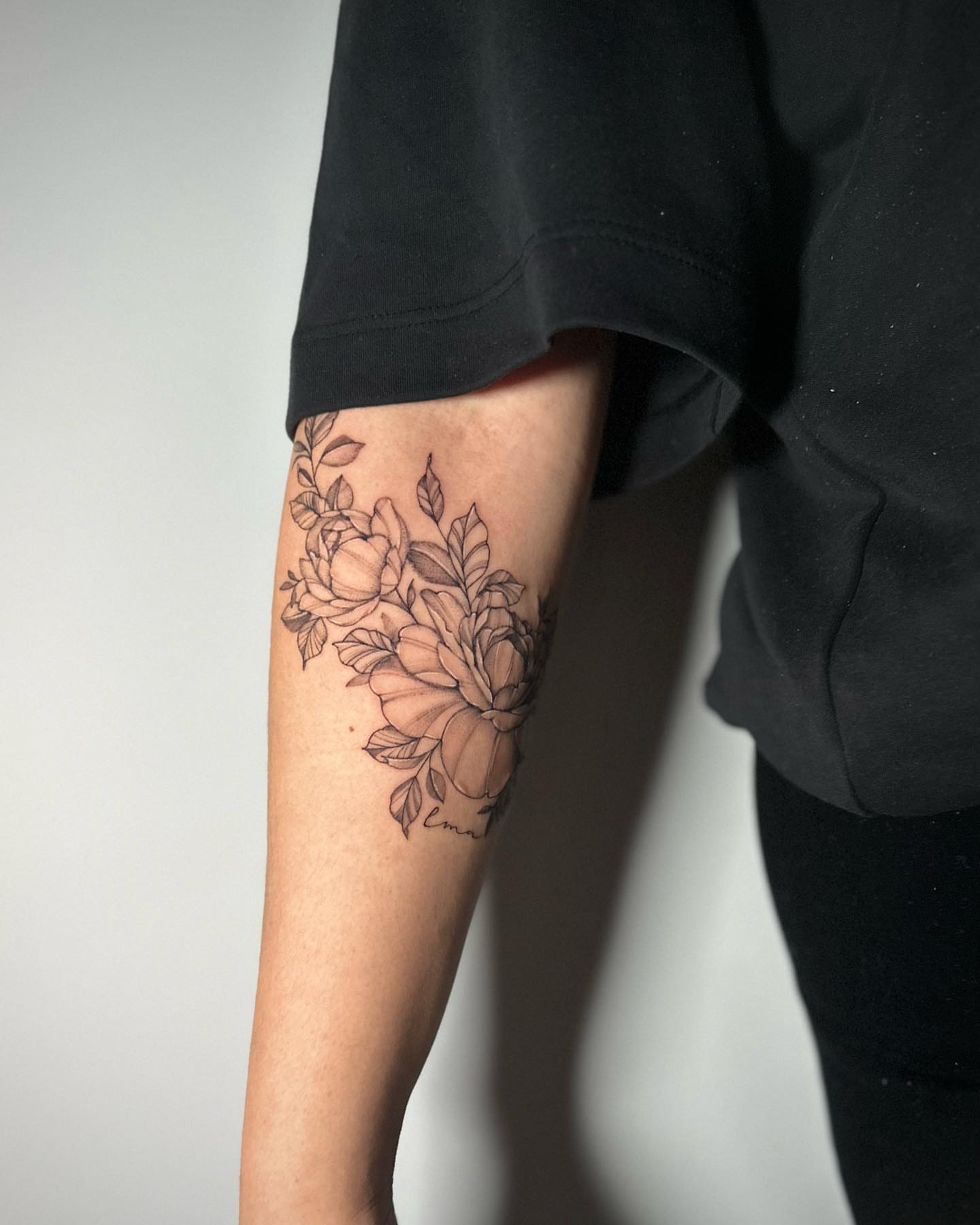 Floral bouquet black and grey tattoo on the forearm by Megan McKee Tattoo Artist