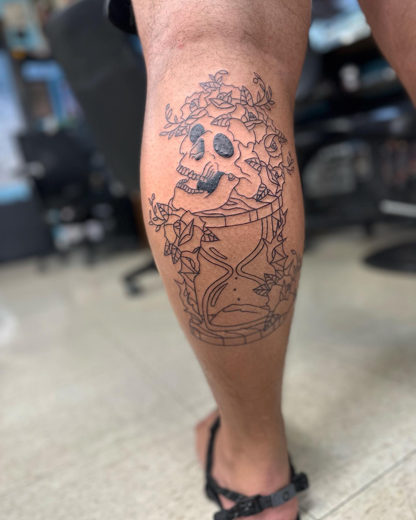 Hourglass and skull black and grey tattoo on the calf by Savy Rasor, Austin, Texas