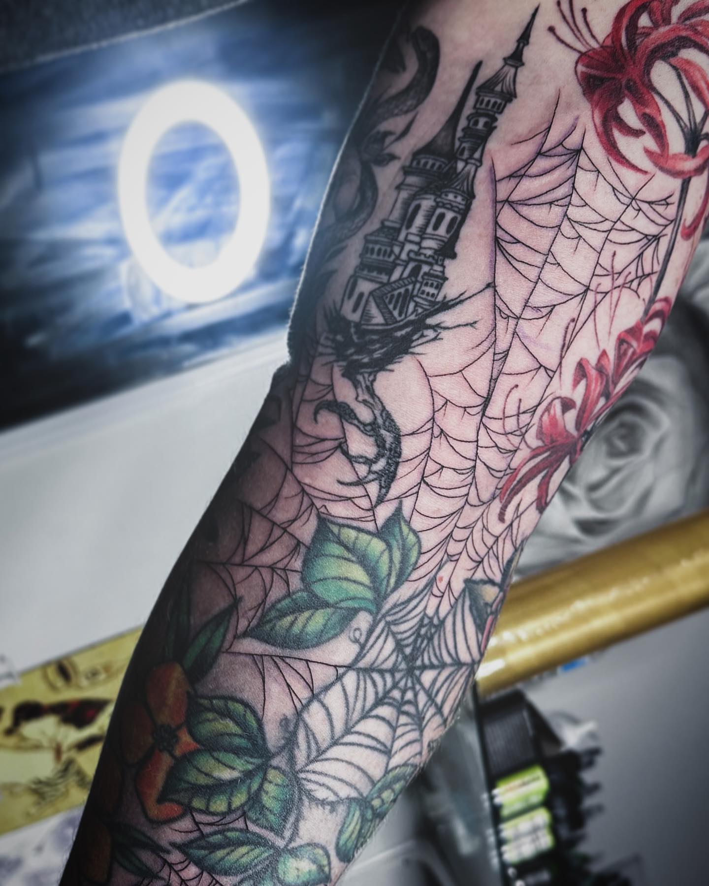 Spiderweb and tower neo-traditional tattoo on the forearm by Rachel Martinez