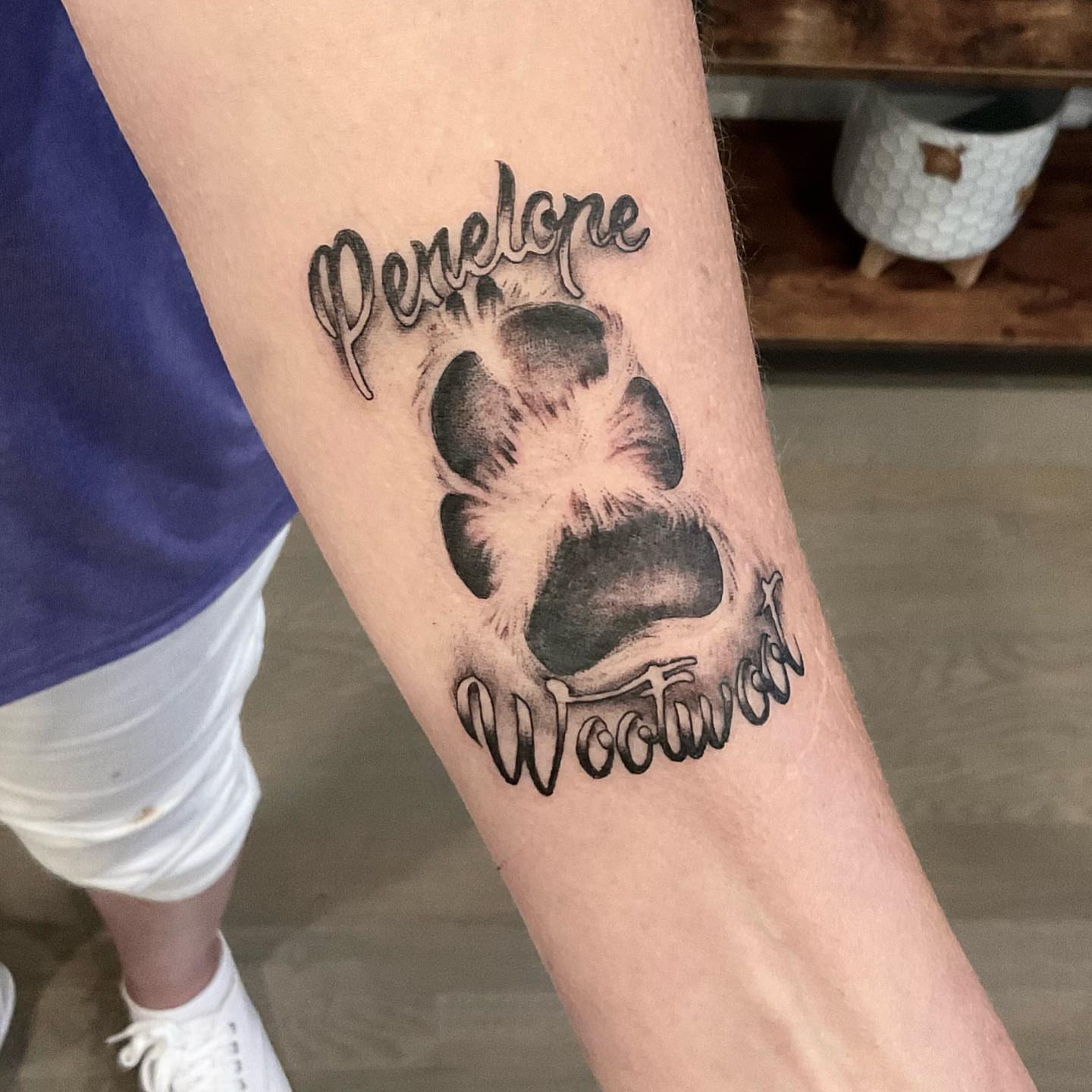 Bear paw print black and grey tattoo on the forearm by Matthew Clanin