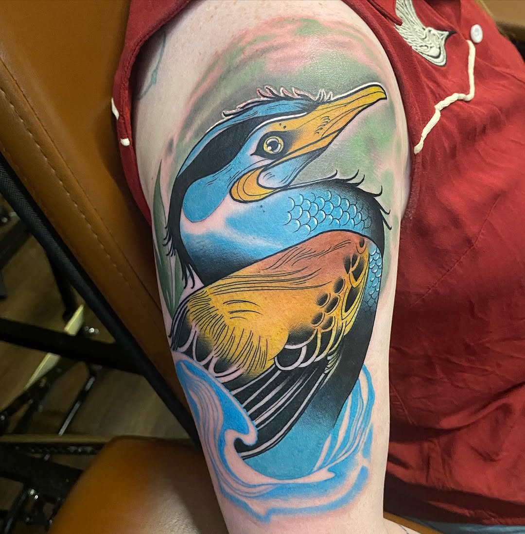 Bird and water watercolor tattoo on the upper arm by Duff McCormack