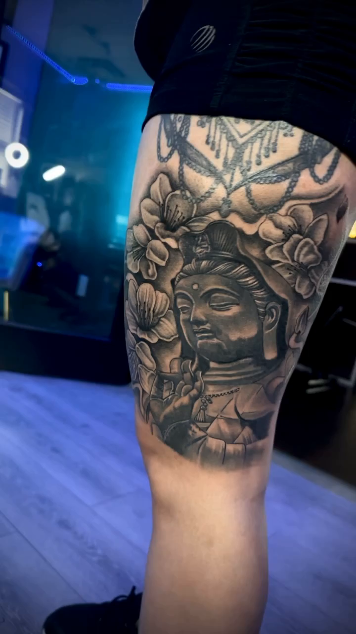Buddha head with floral elements realism tattoo by Paul burrows (Tatttoo Artist)