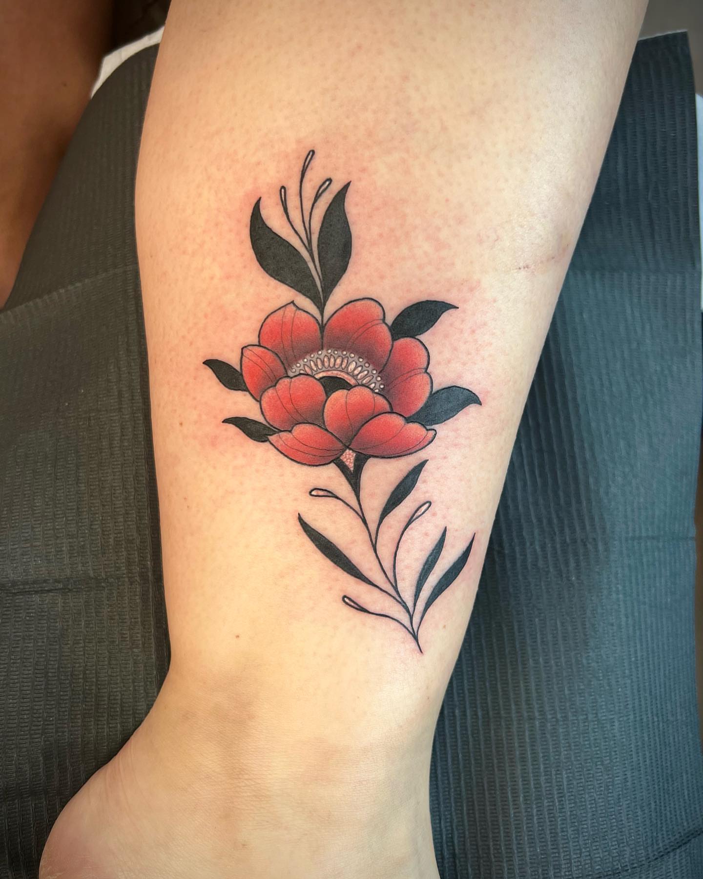 Peony American traditional tattoo on the forearm by Mia Manzanedo