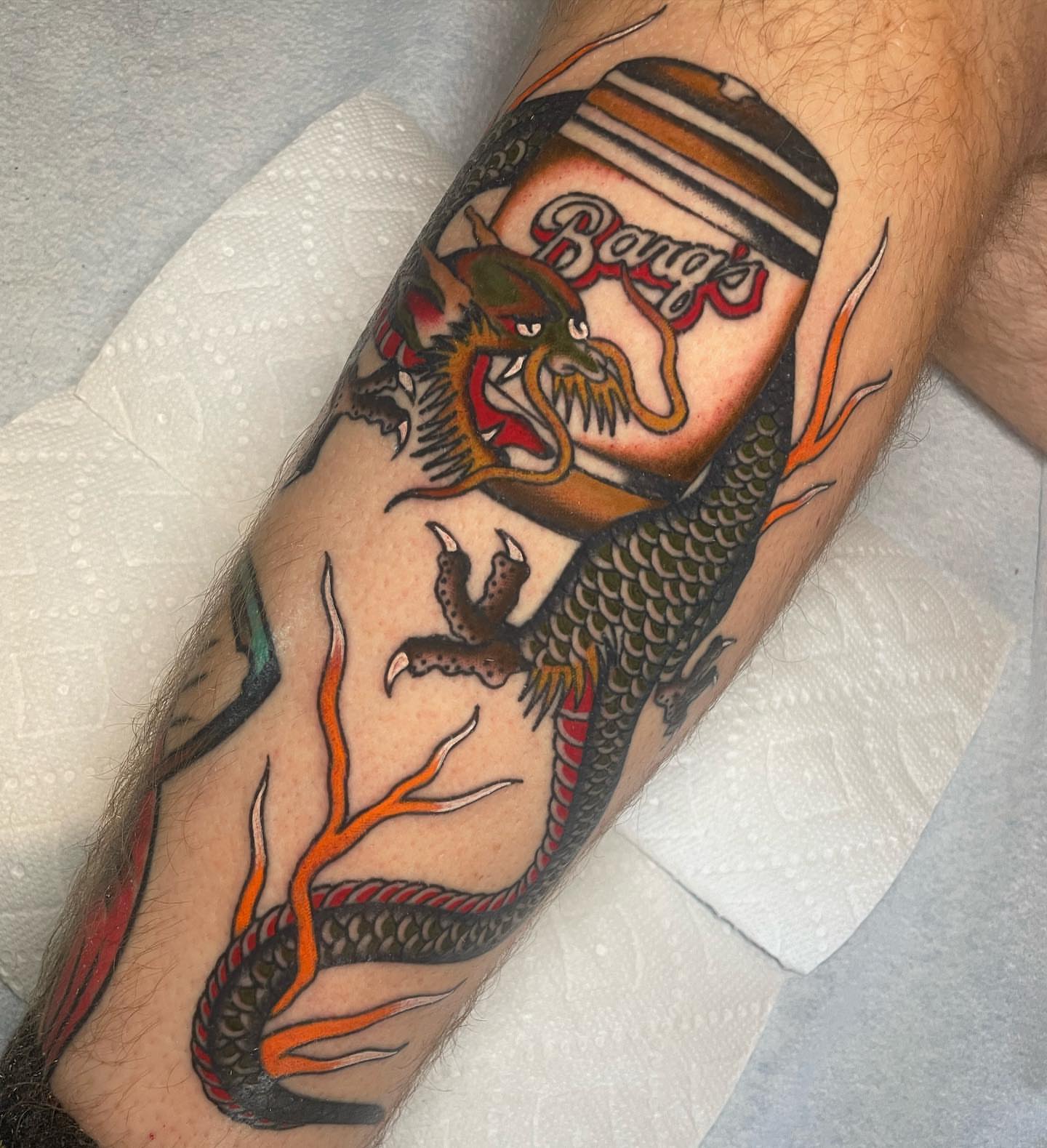 Dragon and Burger's can American traditional tattoo on the forearm by Toulouse Noble, Portland, Oregon