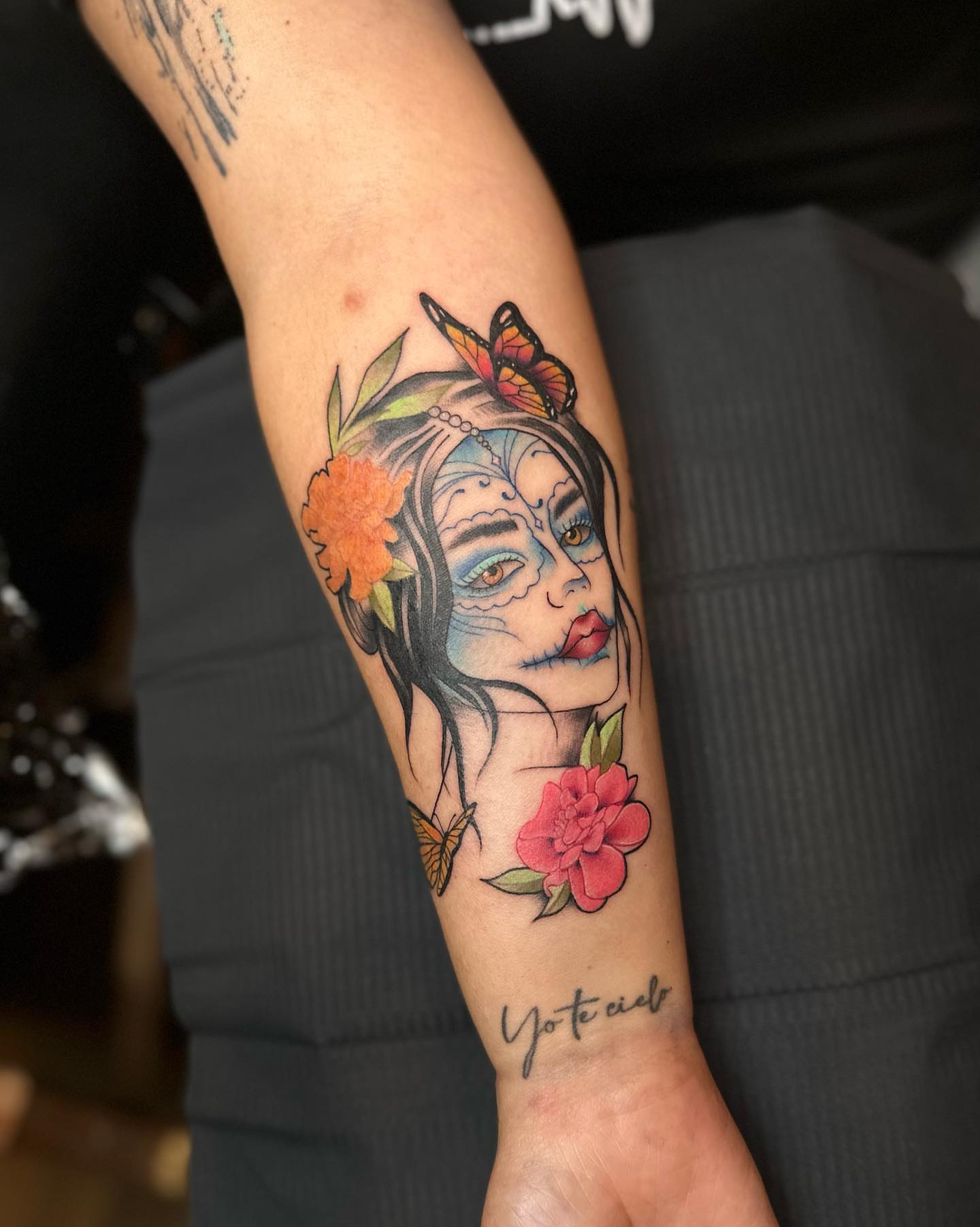 Sugar skull with flowers American traditional tattoo on the forearm by alex h🪴 neotrad