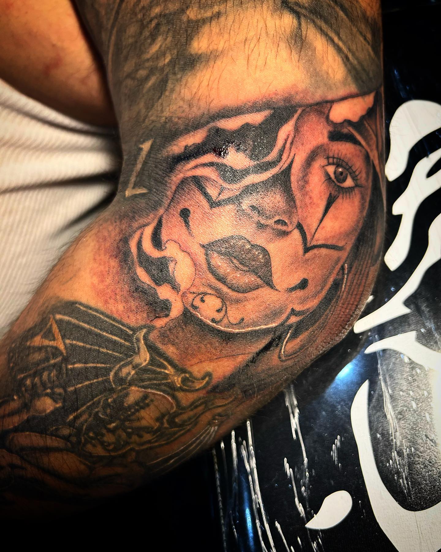 Abstract face realism tattoo on the forearm by Visionary Tattoos