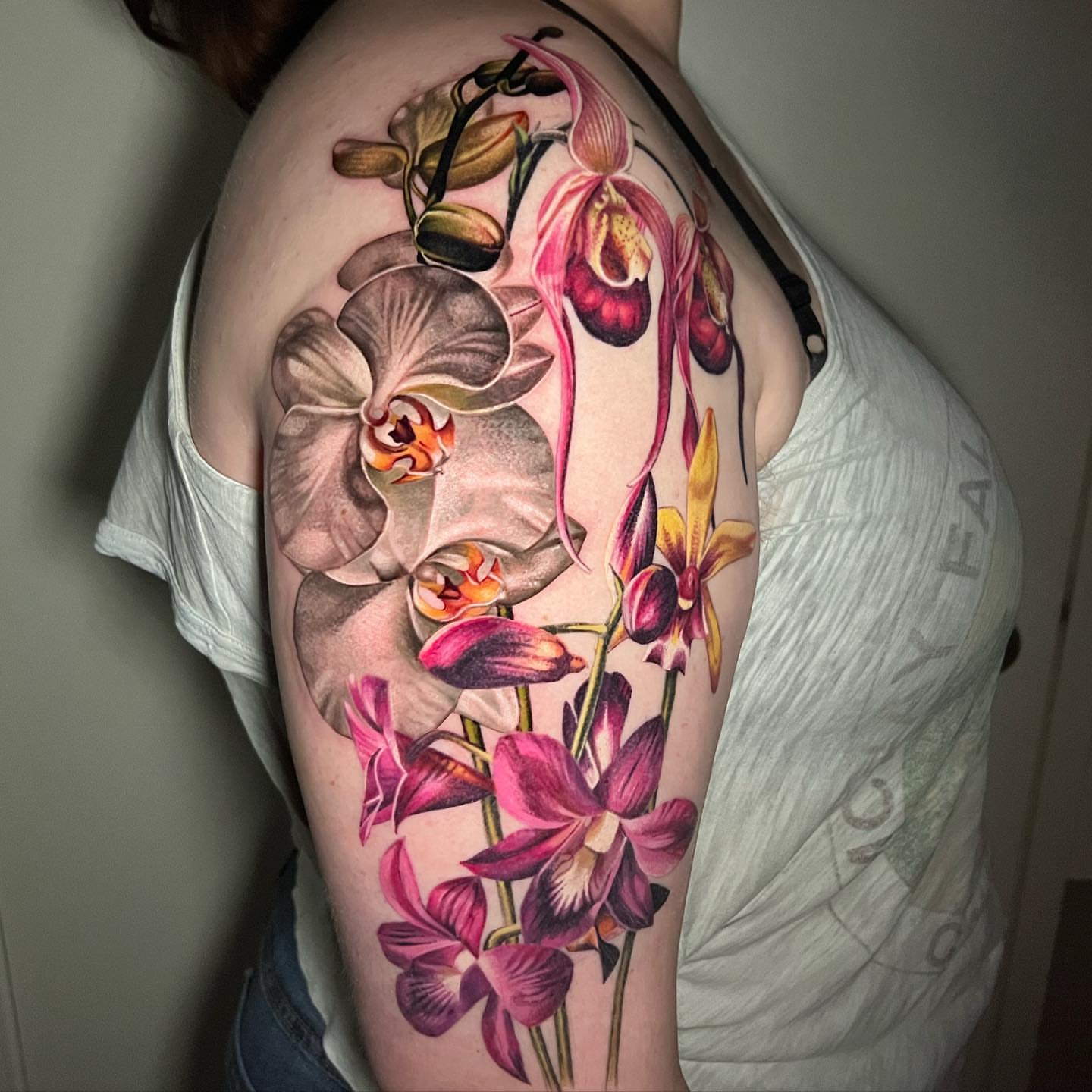 Orchids realism tattoo on the shoulder by Irina Shapiro, Somerville, Massachusetts