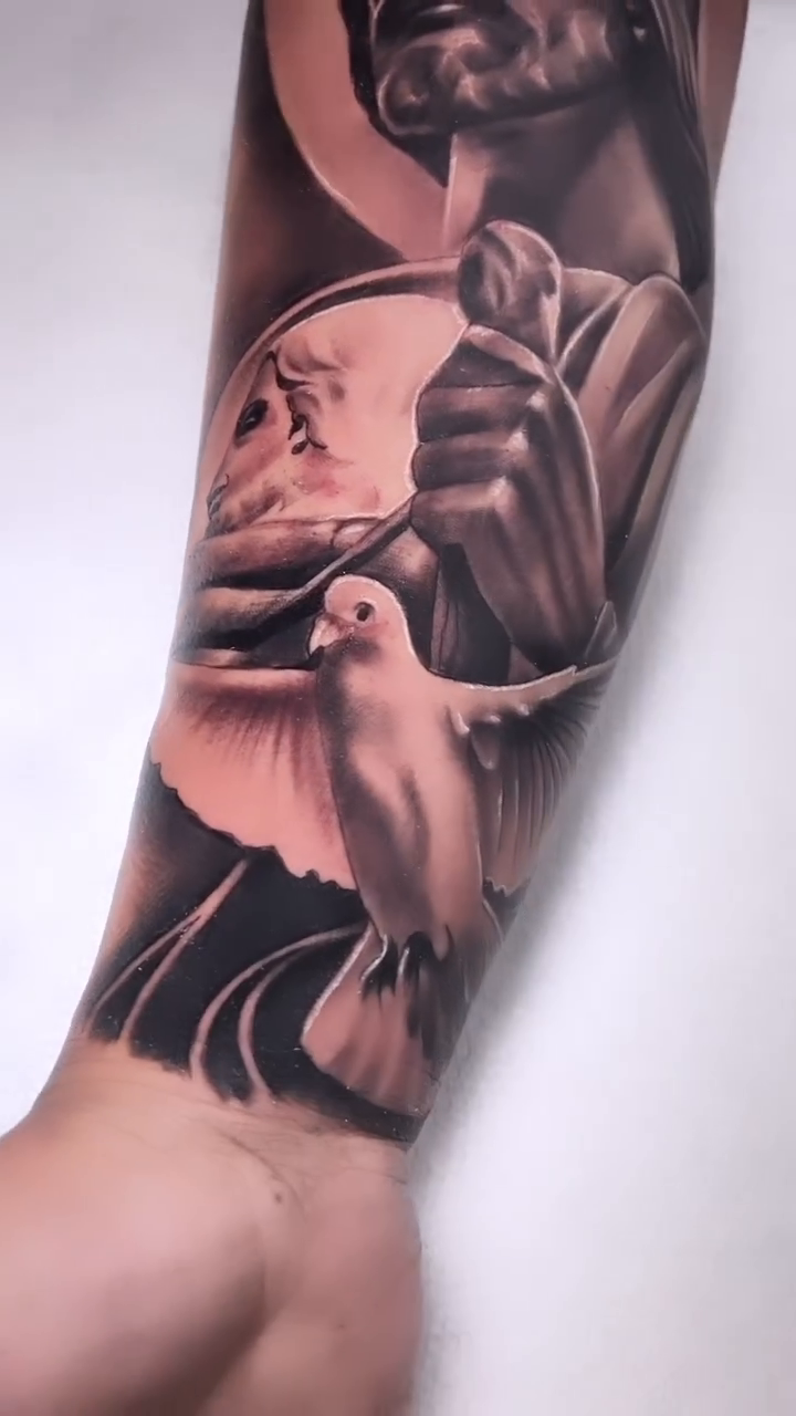 Jesus Christ with a dove realism tattoo by Tattoo