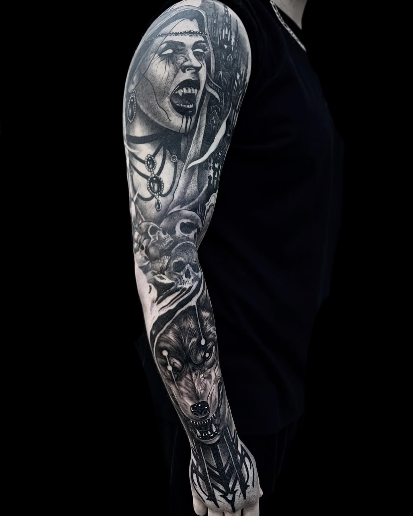 Woman with wolf realism tattoo on the upper arm by Briana Walker