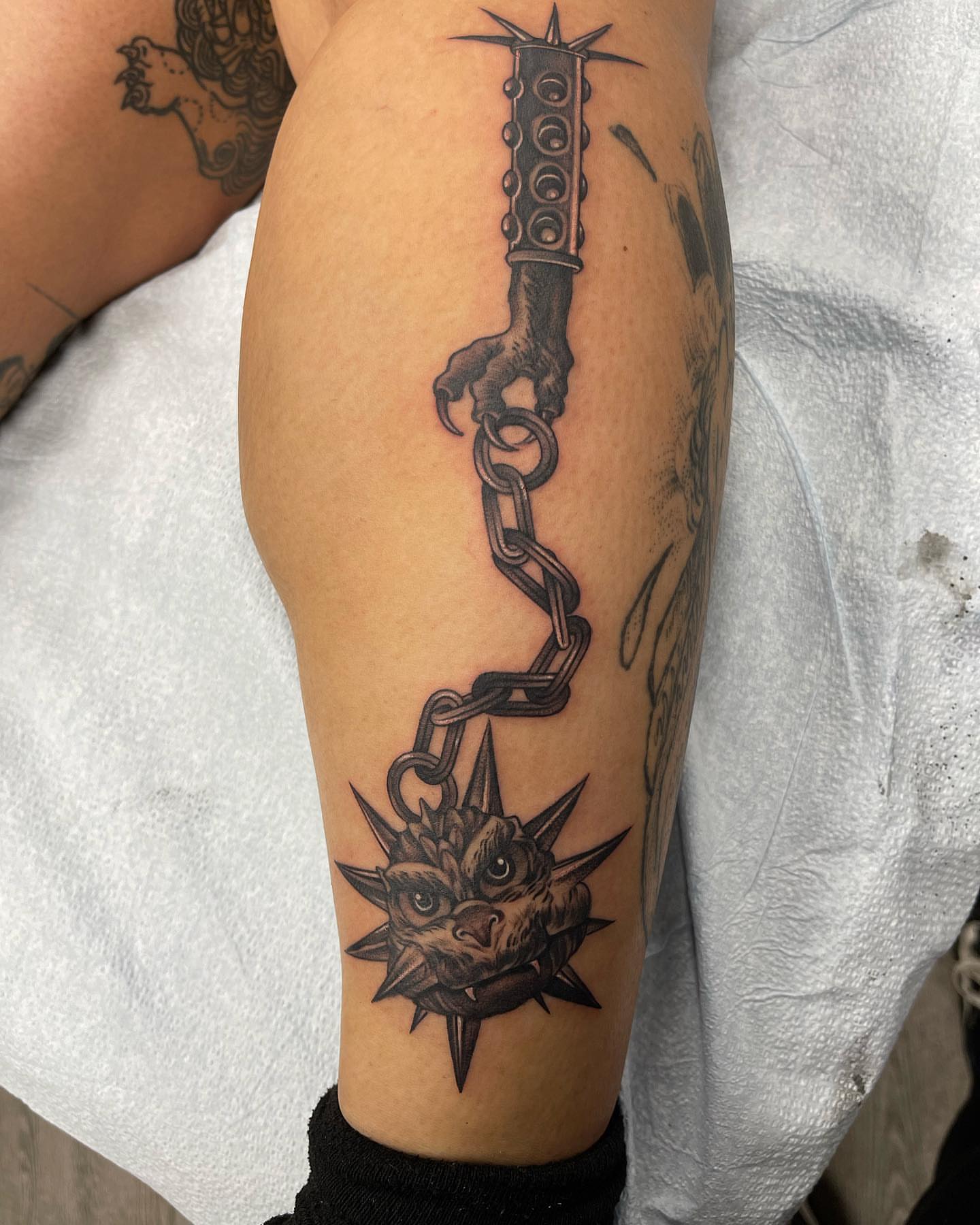 Chainsaw and dragon black and grey tattoo on the forearm by Carla V