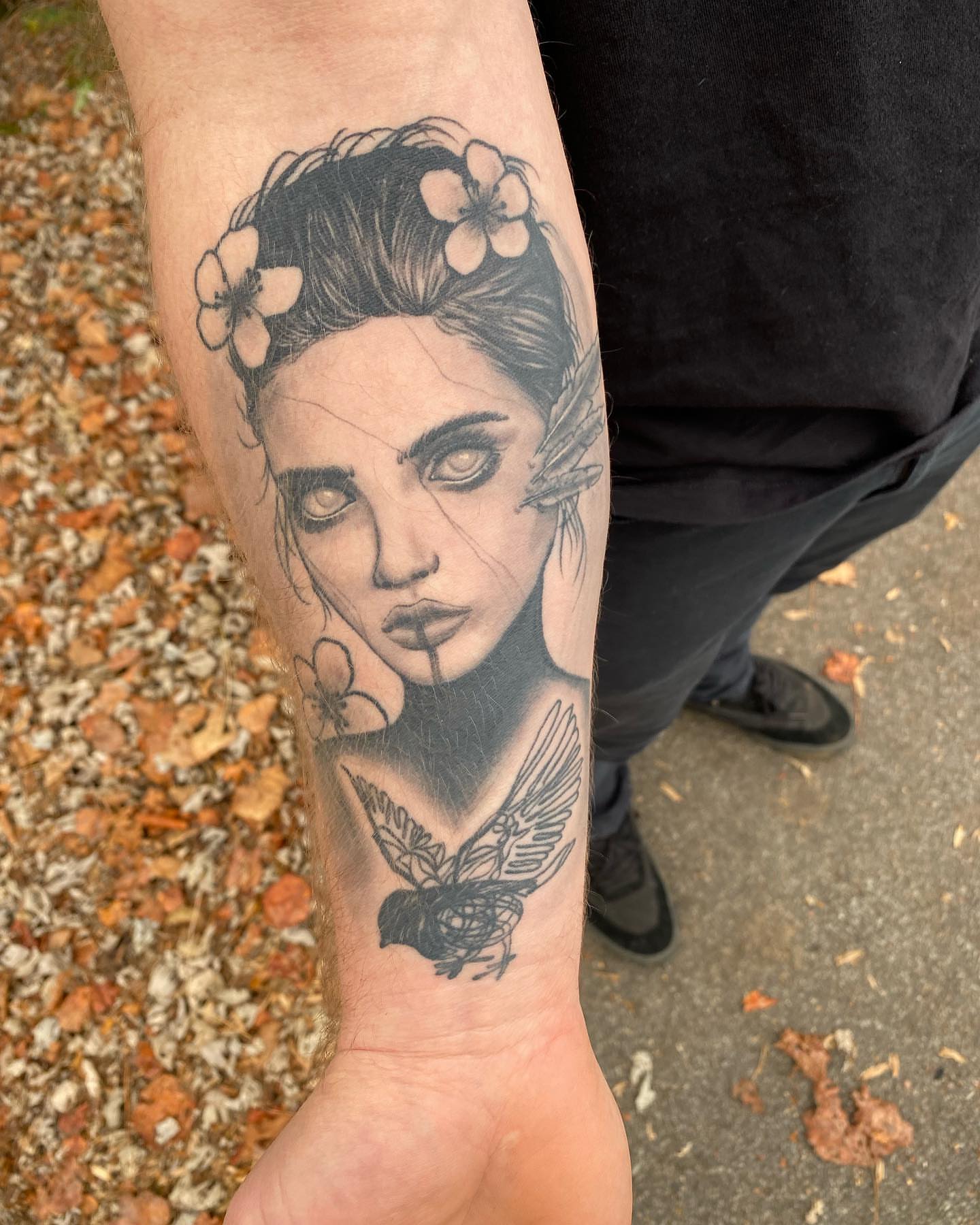 Woman with flowers realism tattoo on the forearm by Tucker, Maryville, Tennessee