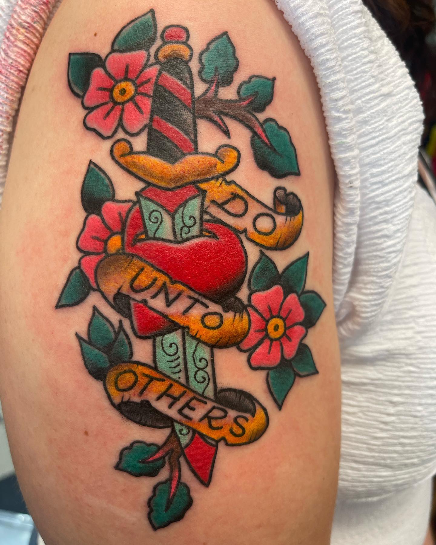 Heart with banner American traditional tattoo on the upper arm by Edward Choat