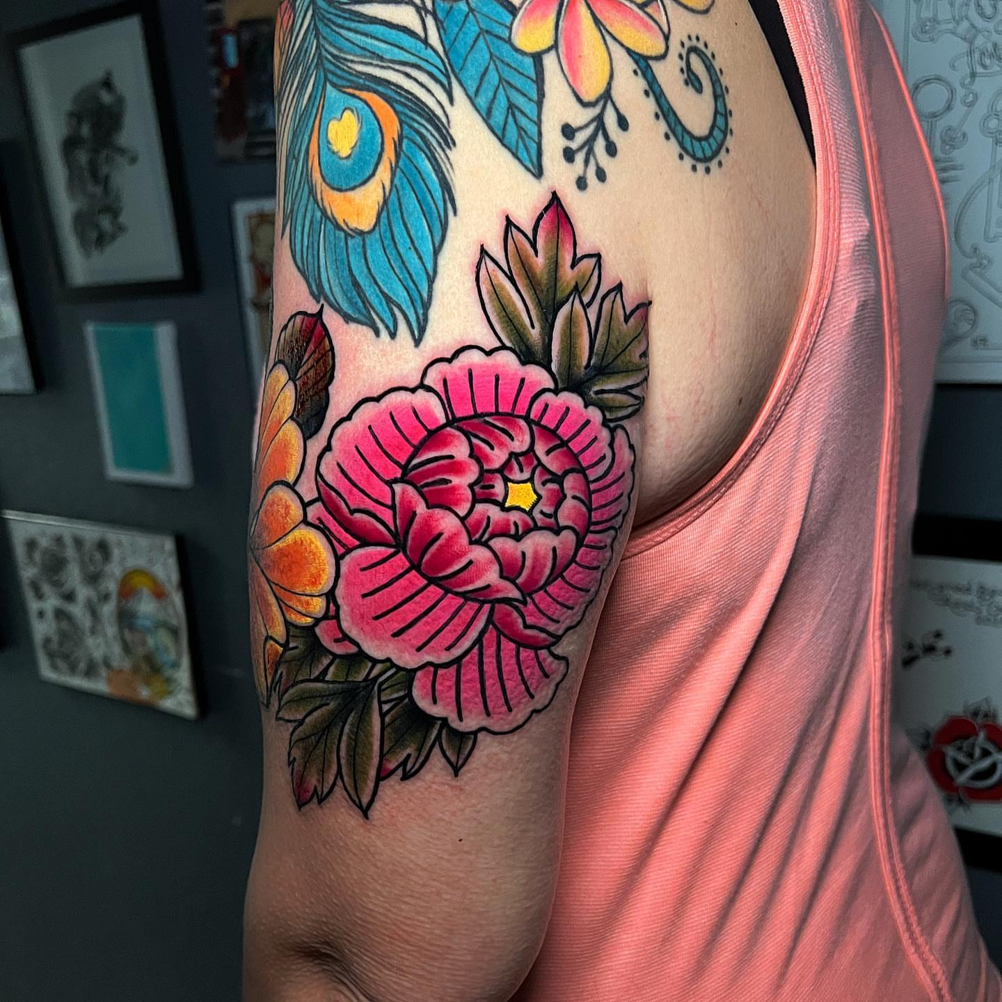 Peony flower American traditional tattoo on the upper arm by Raul Ortiz