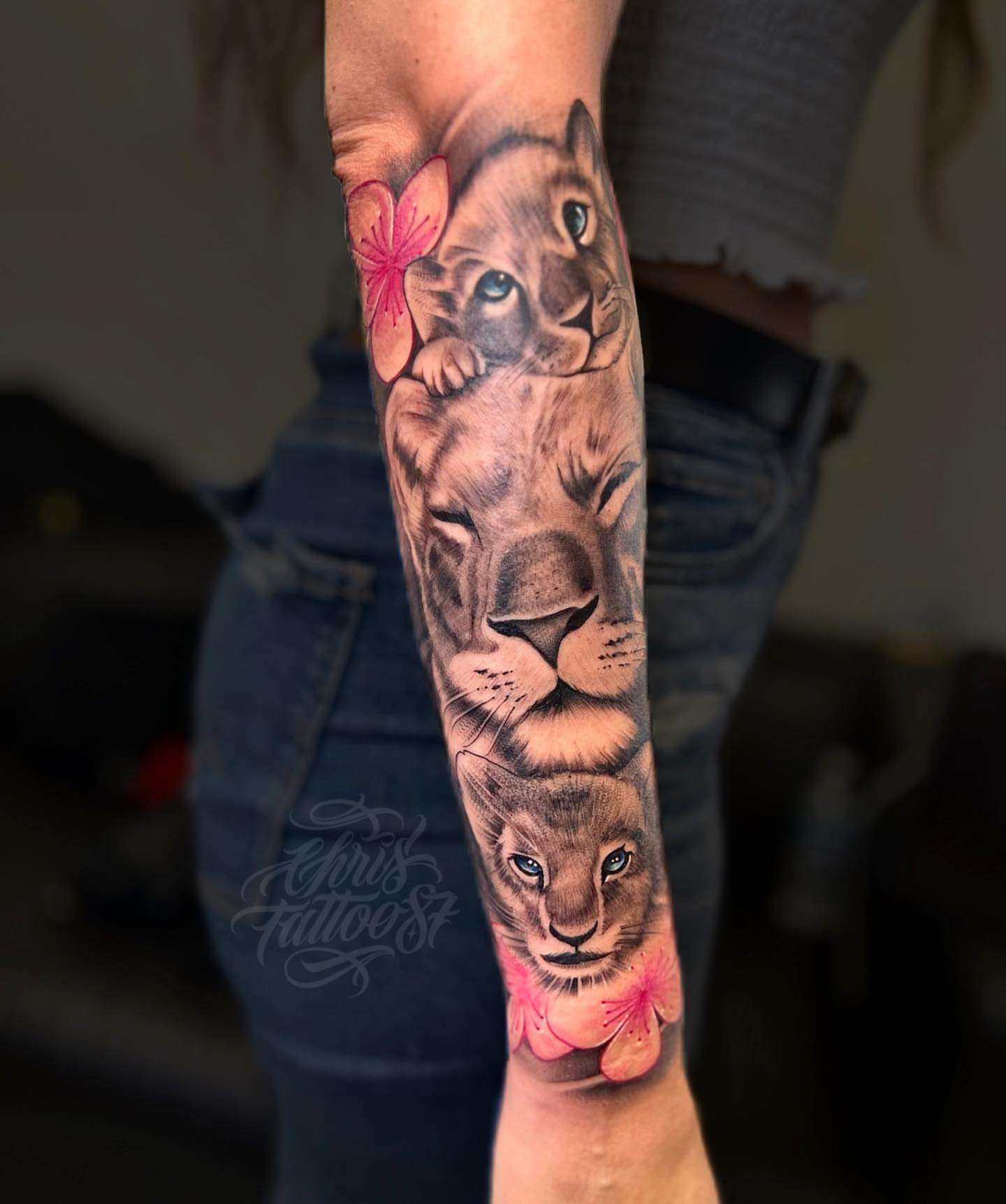 Lion family realism tattoo on the forearm by chris tattoo