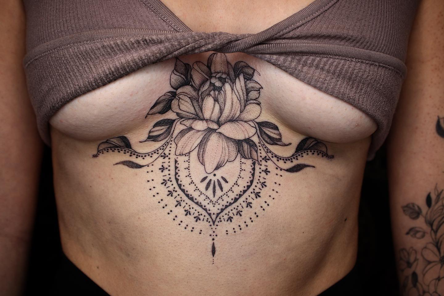 Lotus flower dotwork tattoo on the ribs by Aim 🤍