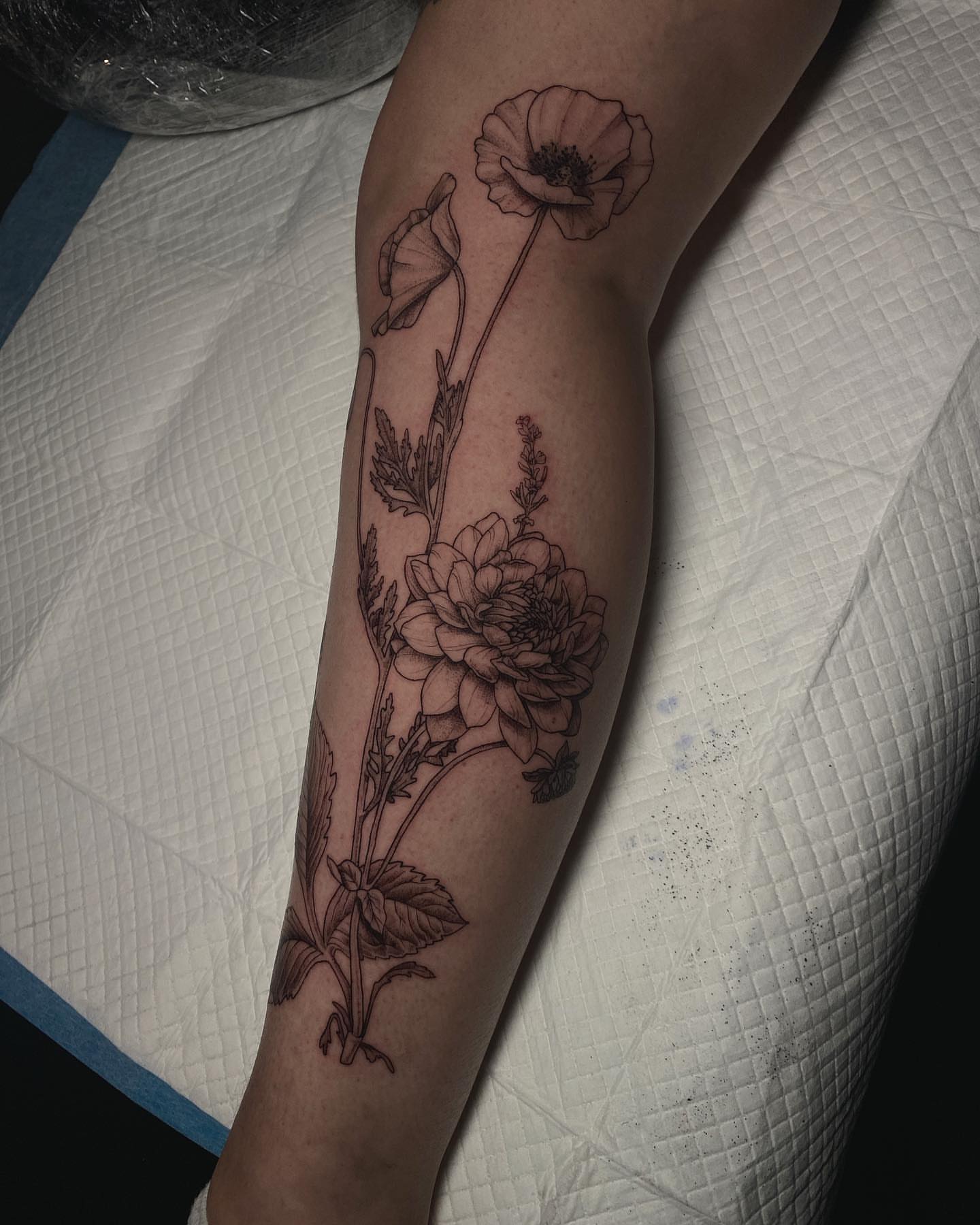 Flower bouquet black and grey tattoo on the forearm by Sydney Dixon, Sacramento, California