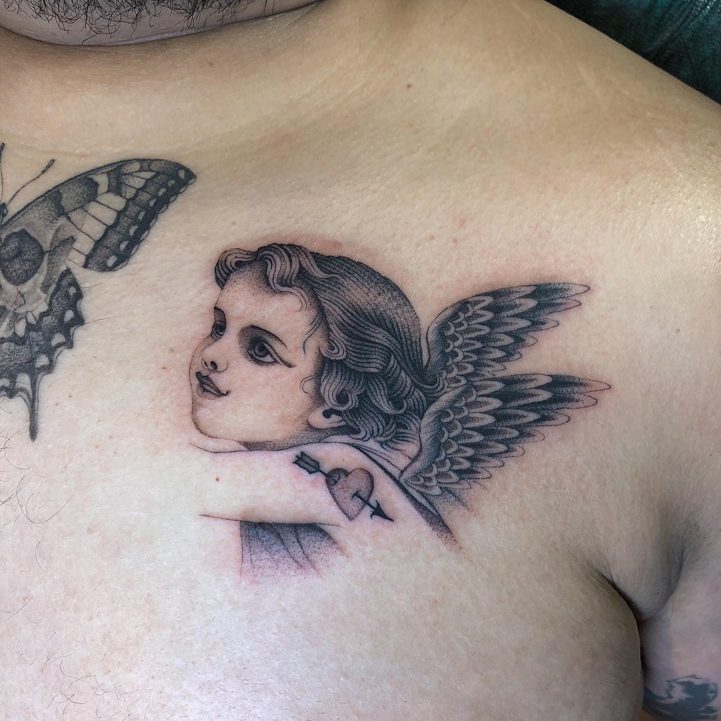 Angel child realism tattoo on the chest by Mickey
