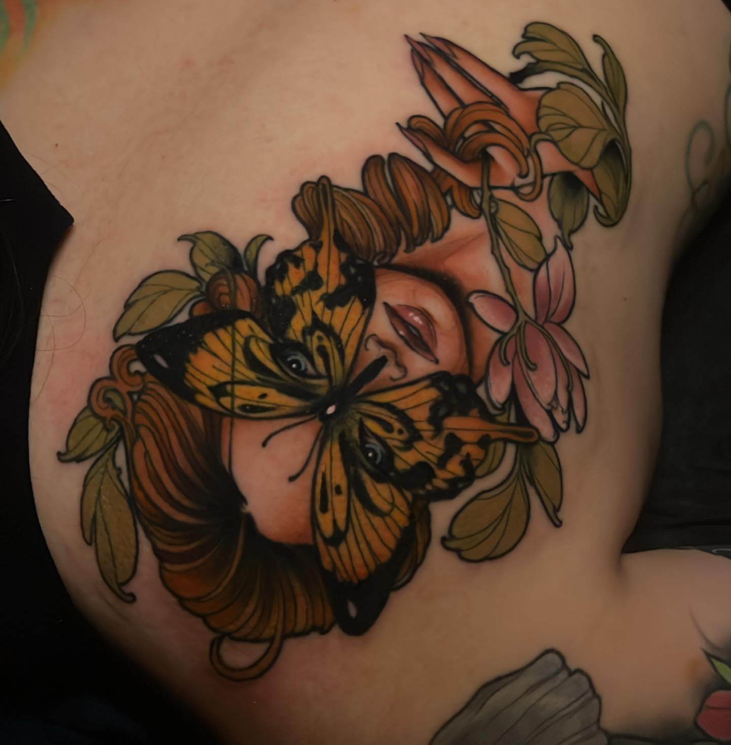 Butterfly and flowers American traditional tattoo on the chest by Tony Trophy