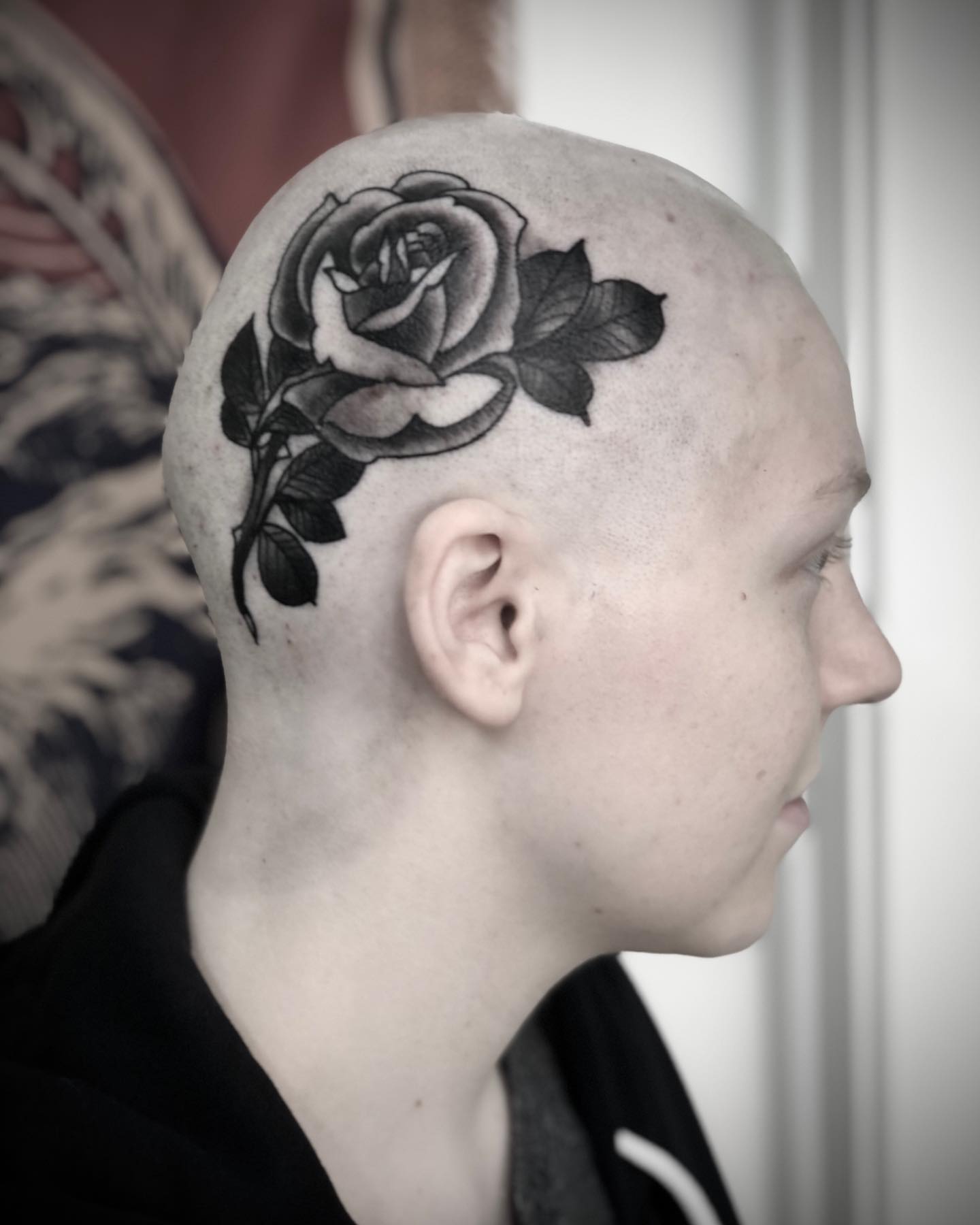 Rose black and grey tattoo on the head by Alec Bauer